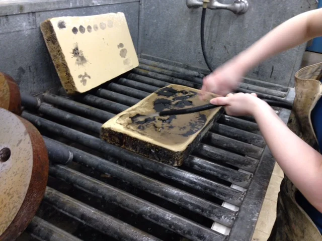  The grease is starting to come off of the light areas of the piece revealing the stone. 