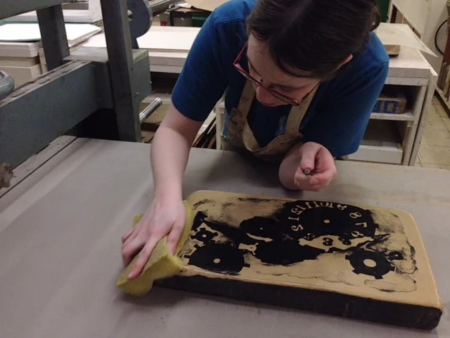  In between rolling on the ink, I sponge the stone to keep it damp. If any area of stone dries out, the next roll of ink will stick to the area no longer being protected by water. 