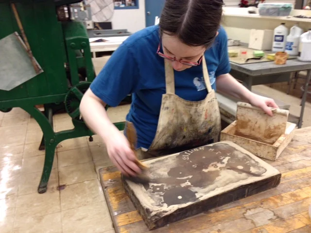  Rosin and talc. It was repeated by my professor so many times, that I can't forget it. The stone is dusted with rosin that stick to the greasy ink, setting the image on the stone. 