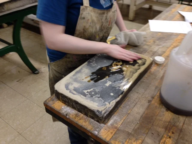  Once the entire stone face is covered, I use cheesecloth to buff off all the excess gum arabic. After a short dry time, I put a paper cover on the stone and put it back on the shelf. When I want to print again, I start the process anew. 