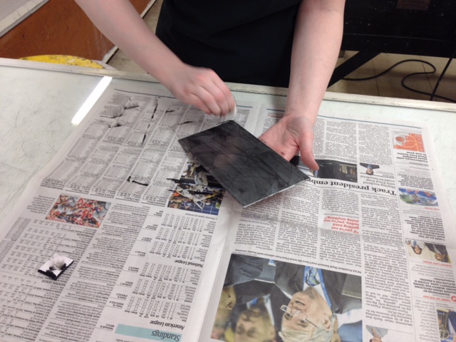  Once the entire plate has been covered in ink, I can begin to wipe off the excess ink which is causing the streaked black lines across the plate. 