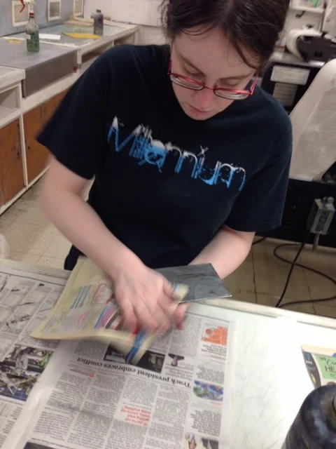  Now I take phonebook paper to wipe off the excess ink using light pressure with my palm. I make sure to clean the edges of the plate to ensure no extra ink ends up on the final print. 