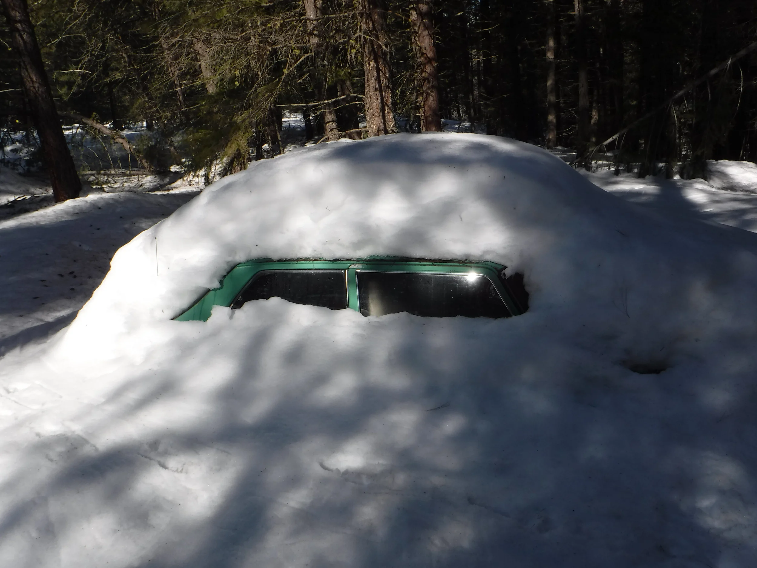 Car left last fall covered in snow. The snow was at least two feet deep.