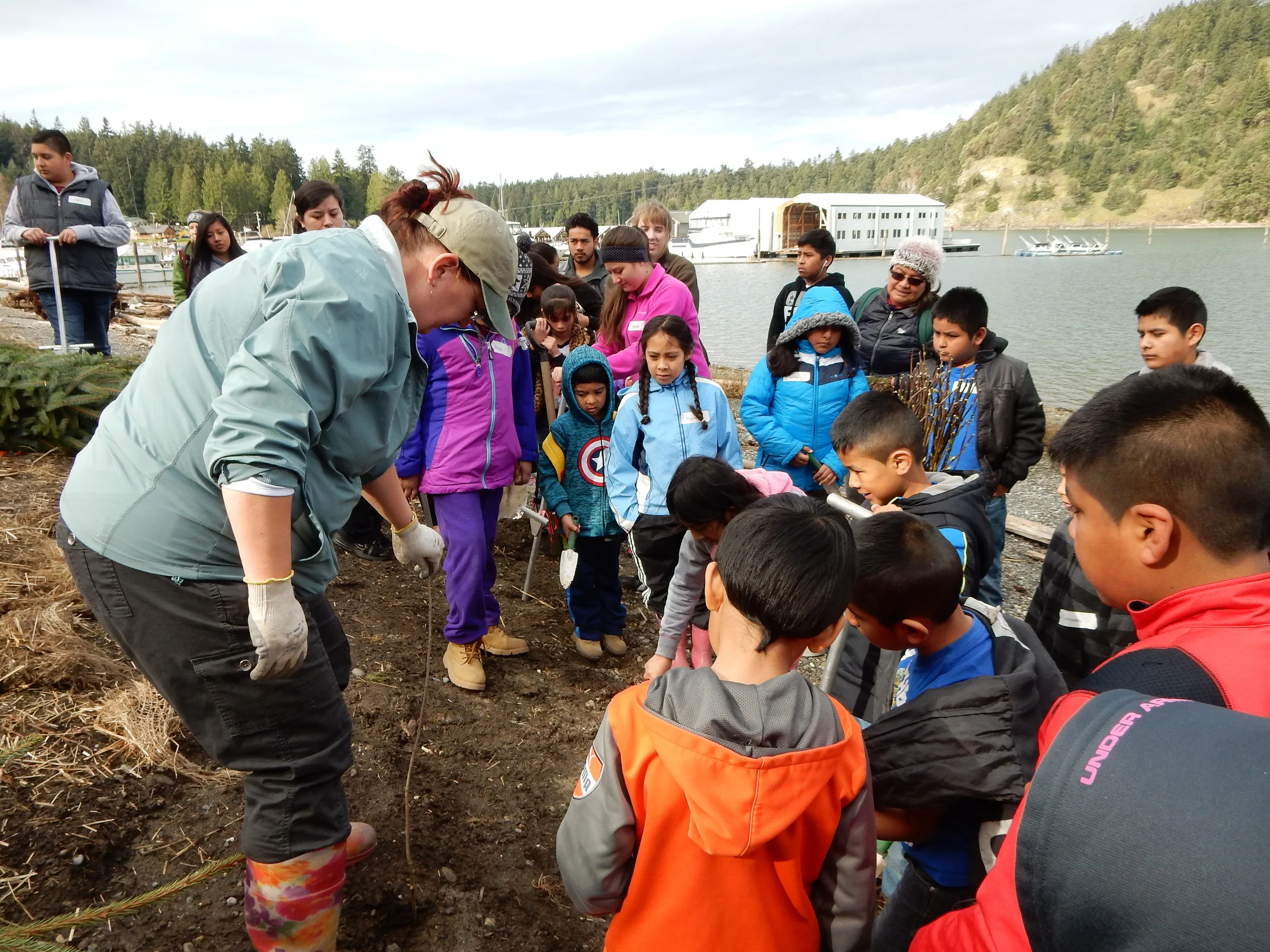 Staff at the Skagit Fisheries Enhancement Group explaining best planting techniques.