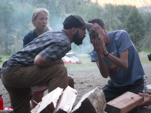 Starting a fire using traditional methods.