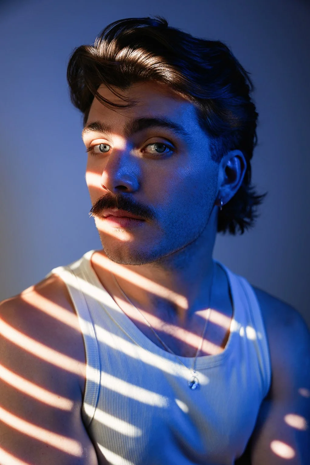 Editorial portrait of musician in studio with dramatic lighting