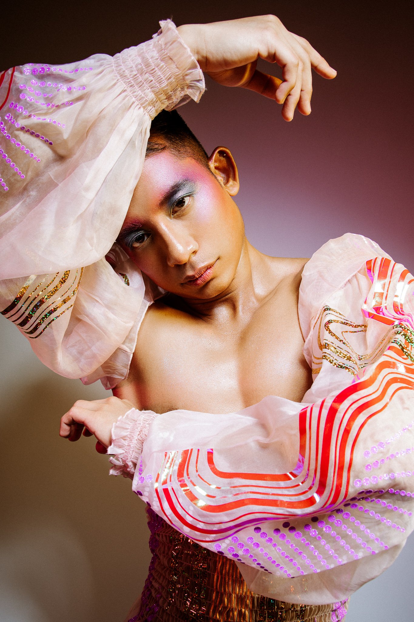 Half-length colourful portrait of aerialist and performer Zaki Musa in ballet-inspired outfit looking at camera