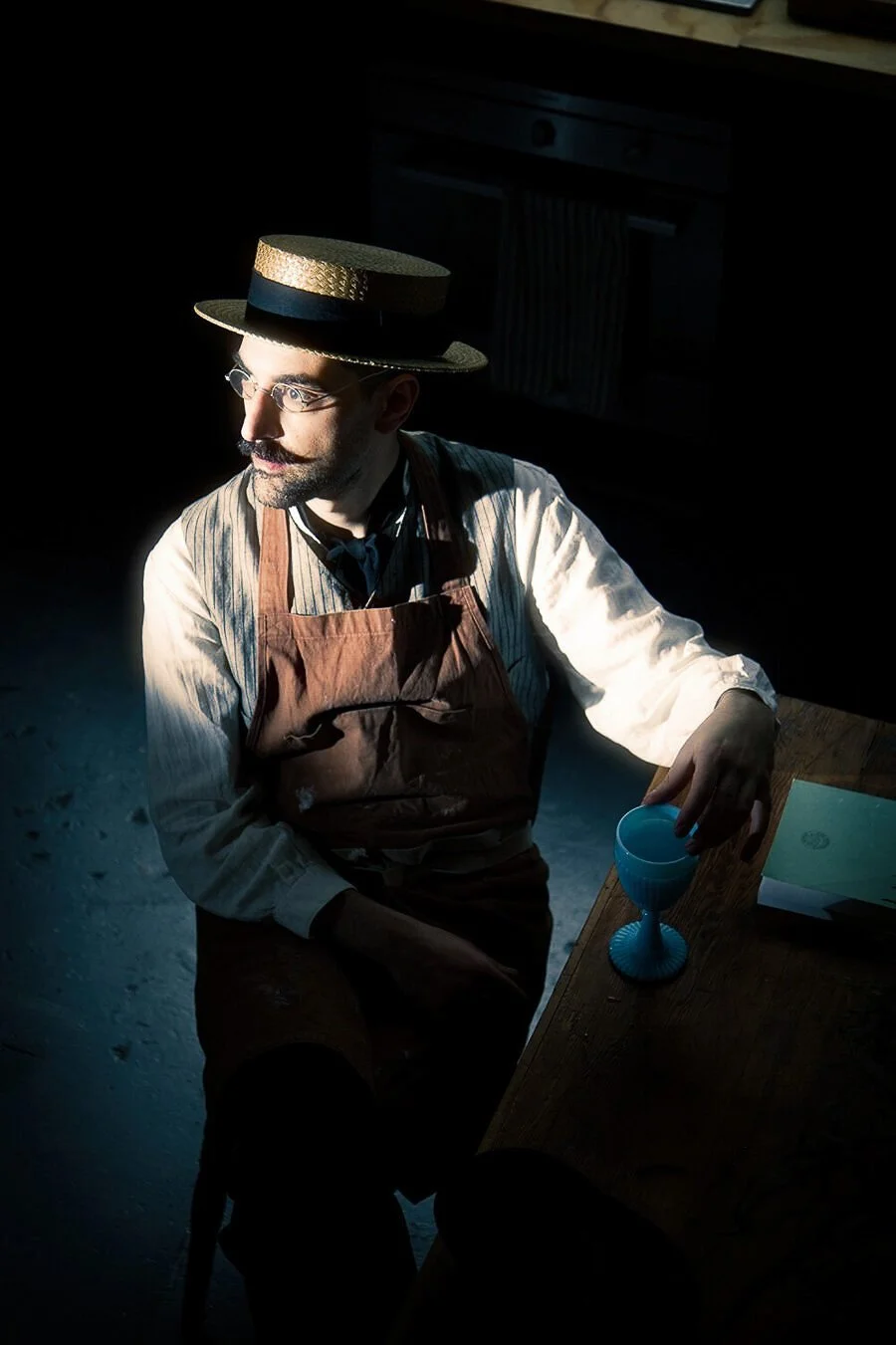 Film noir style portrait of Leonidas (Poupee Mecanique) in his Hackney Wick studio looking into the distance
