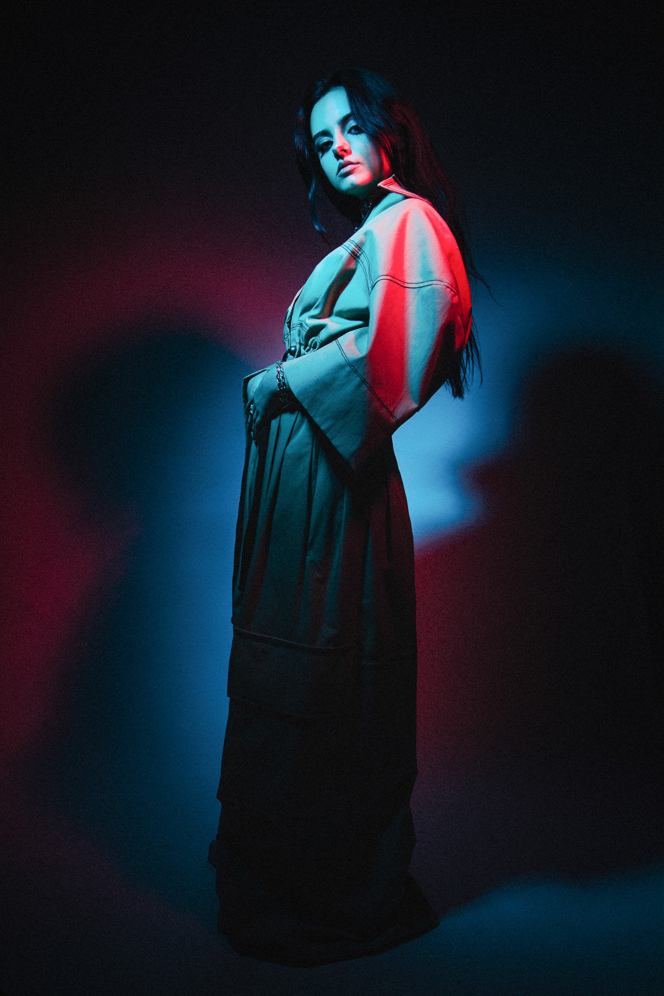 Jessie Murph full-length fashion portrait in blue and red lighting, dark background
