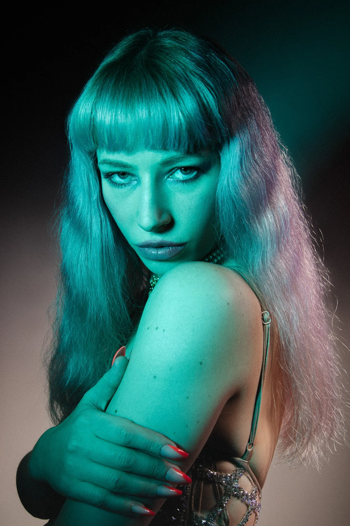 Portrait of model Ausrine Olivia in blue lighting looking directly at the camera