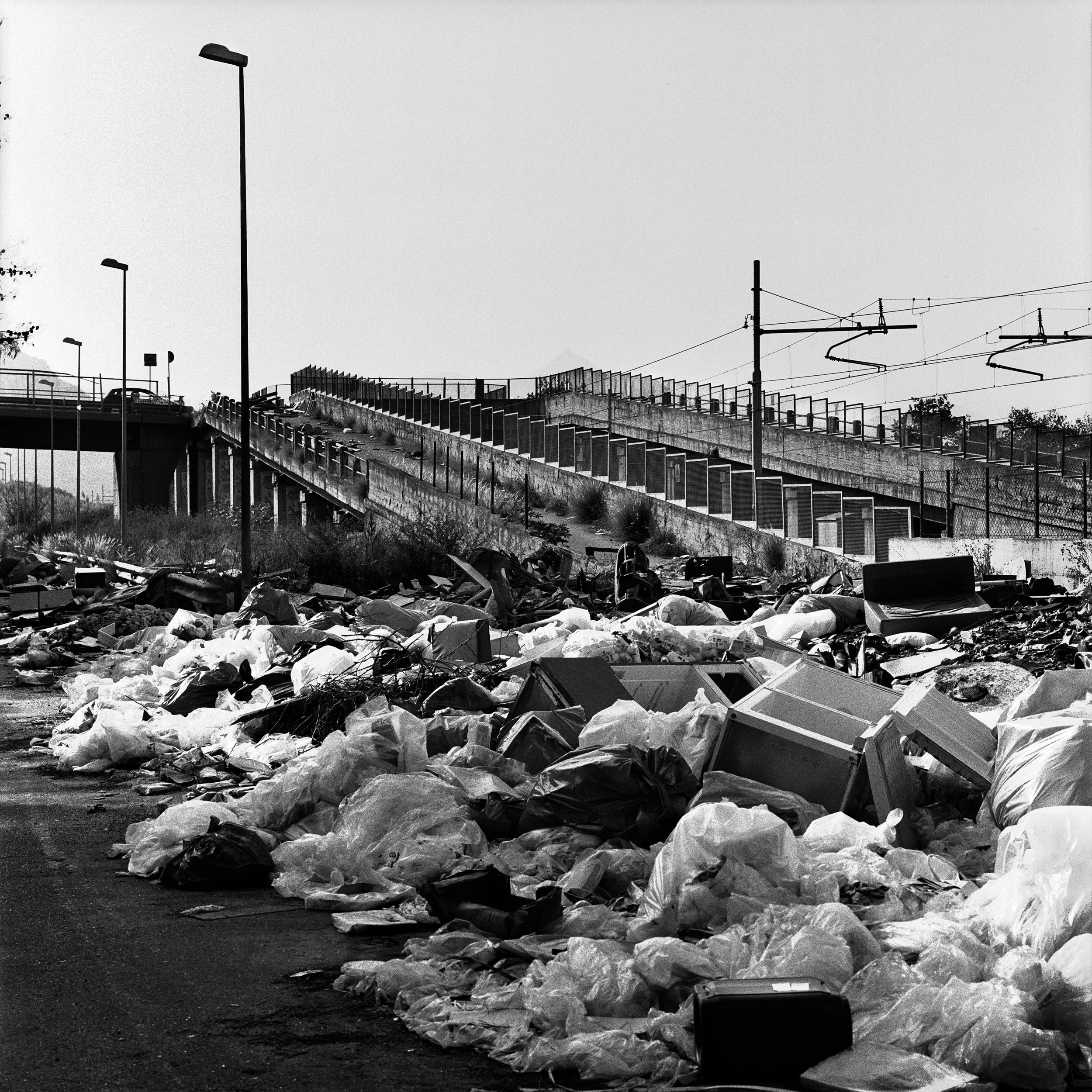  Piles of uncollected refusals invade the carriage of a main road in Brancaccio district on the North-East periphery of Palermo. 