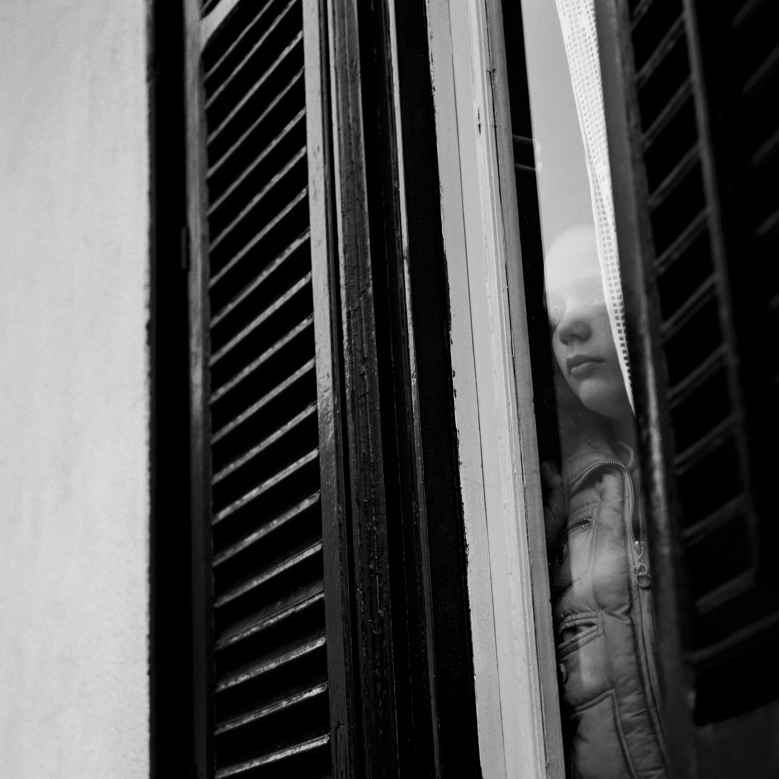  A girl observes through her window in Cinisi, a village near Palermo, a demonstration in rememberance of anti-mafia activist and journalist Peppino Impastato killed by the Badalamenti mafia family on May 9th 1978.  