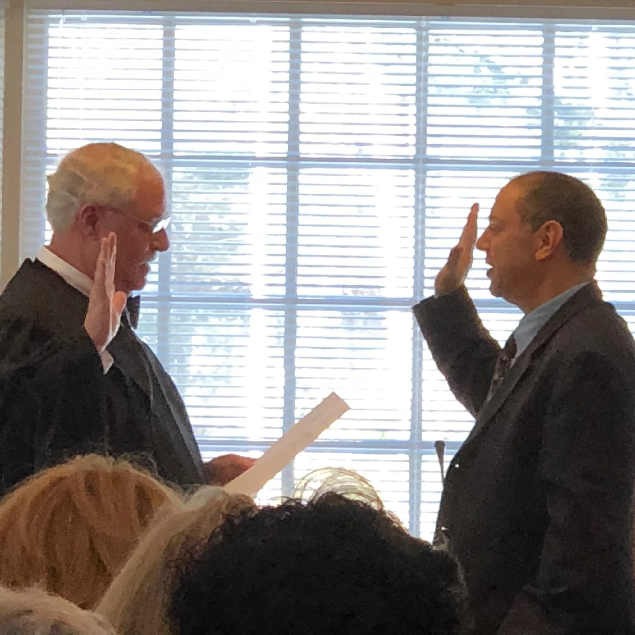 Town Justice Ira Clair swears in reelected incumbent Dan Paschkes as a Town Board member.