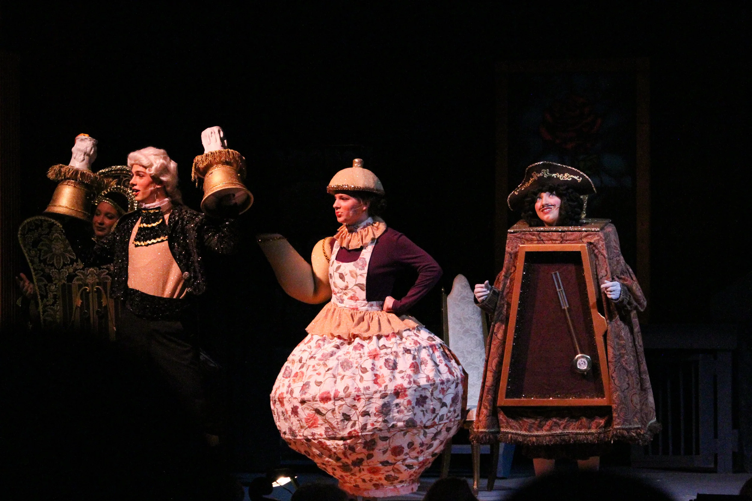 Lumiere the candlestick ( Samuel Lander, senior ), Mrs. Potts the teapot ( Madeline Keenan, Senior ) and Cogsworth the clock ( Tanner Fell, senior ) reminisce what it was like to be human, since being transformed over ten years ago. The costumes were graciously donated with the help of Lander’s grandparents.