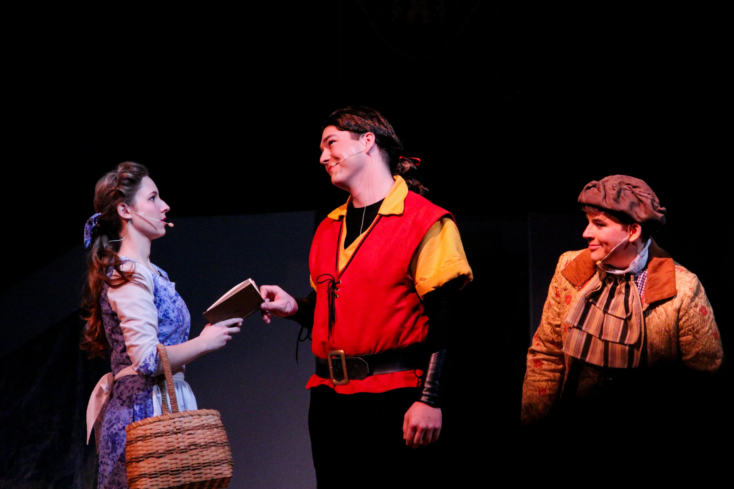 With the use of the new lights purchased by the school board as a donation to the Drama Club. LaFou ( Michael Gunn, freshman ) Gaston ( Ian Best, senior ) and Belle (Emily Powell, senior) take the stage as Gaston, a vain muscular hunter, tries to win Belle’s heart .