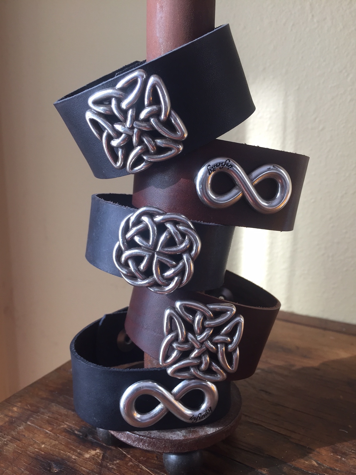Artisan crafted leather bracelets with metal embellishments