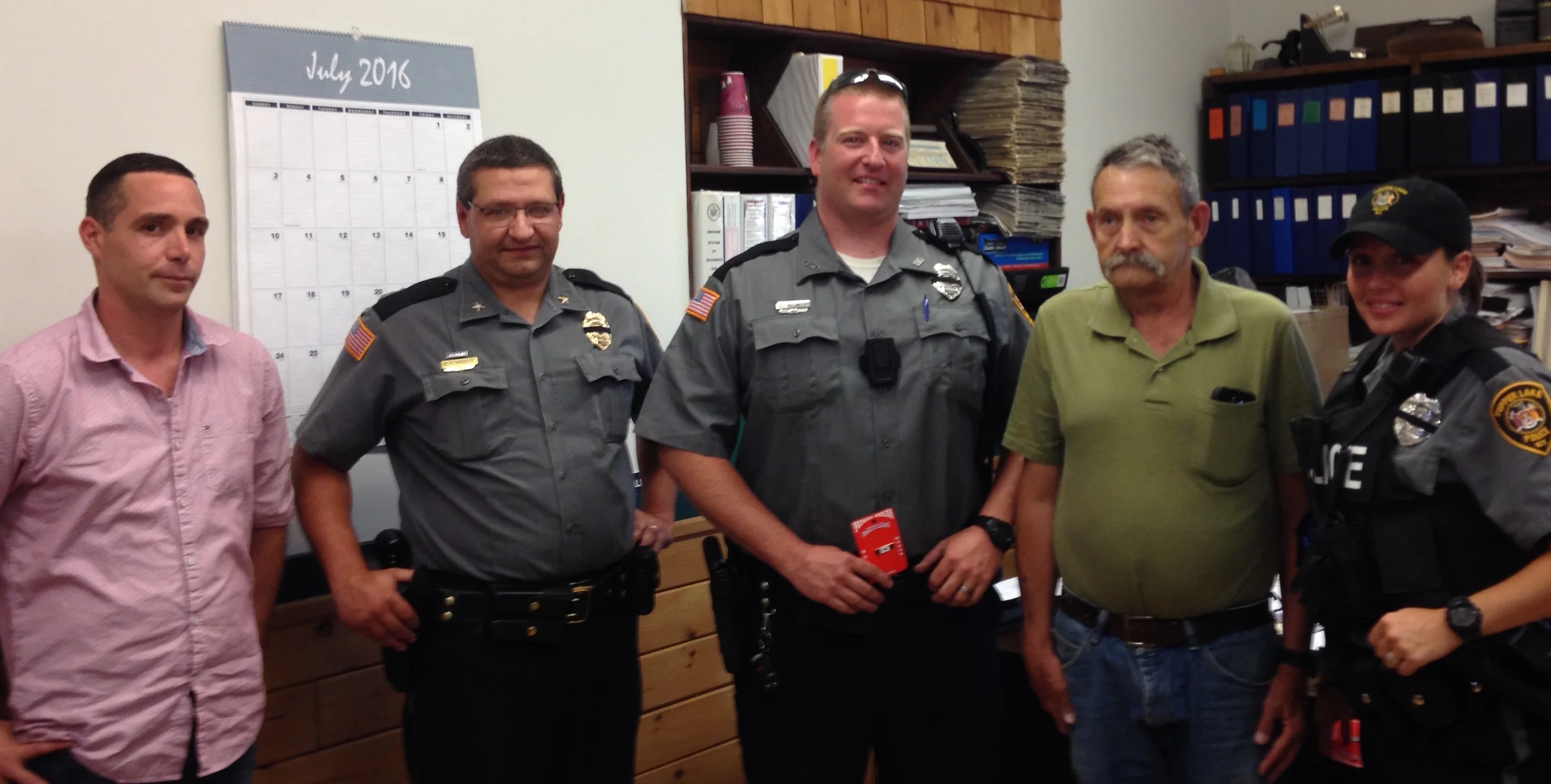 Trustee Ron LaScala and Police Chief Eric Proulx (both at left) posedwith the two officers recognized Wednesday for their life-saving deeds, Michael Vaillancourt and Heather Kennedy, who were flanking the man they saved last December, Randall Rolley. (McClelland photo)