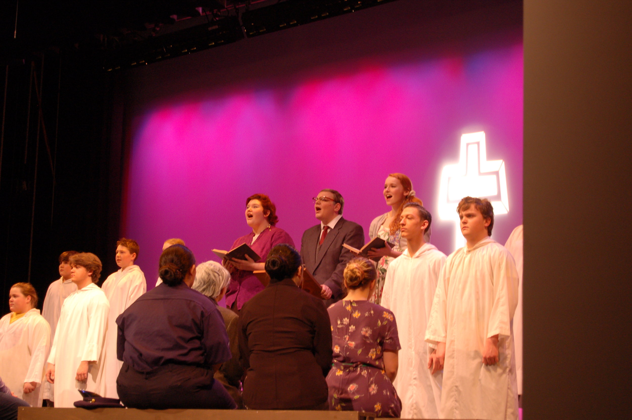   The alter “boys” from left, Shae Arsenault, Garrett Dewyea, Bryce Davison, Cody Auclair, Jayce Clement and Lowden Pratt.    Faced away, from left, Emily Roberts, Olivia Ellis, Karen Bujold and Caitlynn Flemming. And in mid-song from left, Sadie Joh