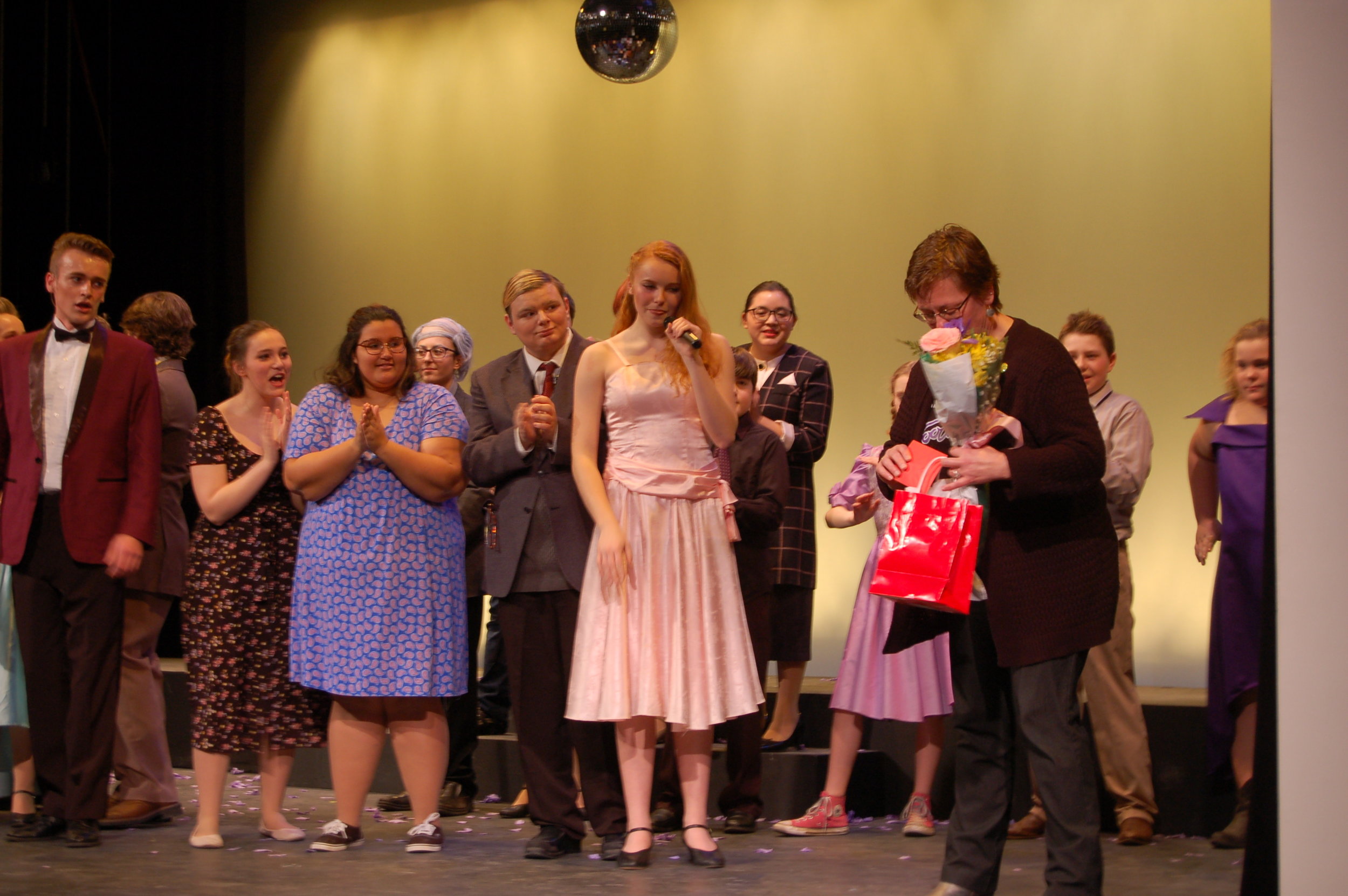   After Sunday’s matinee, to send off the show’s last performance, members of the cast and crew made special remarks and thanks, giving and accepting cards and flowers. Music director Liz Cordes, far right, accepts a gift from the show’s cast and cre