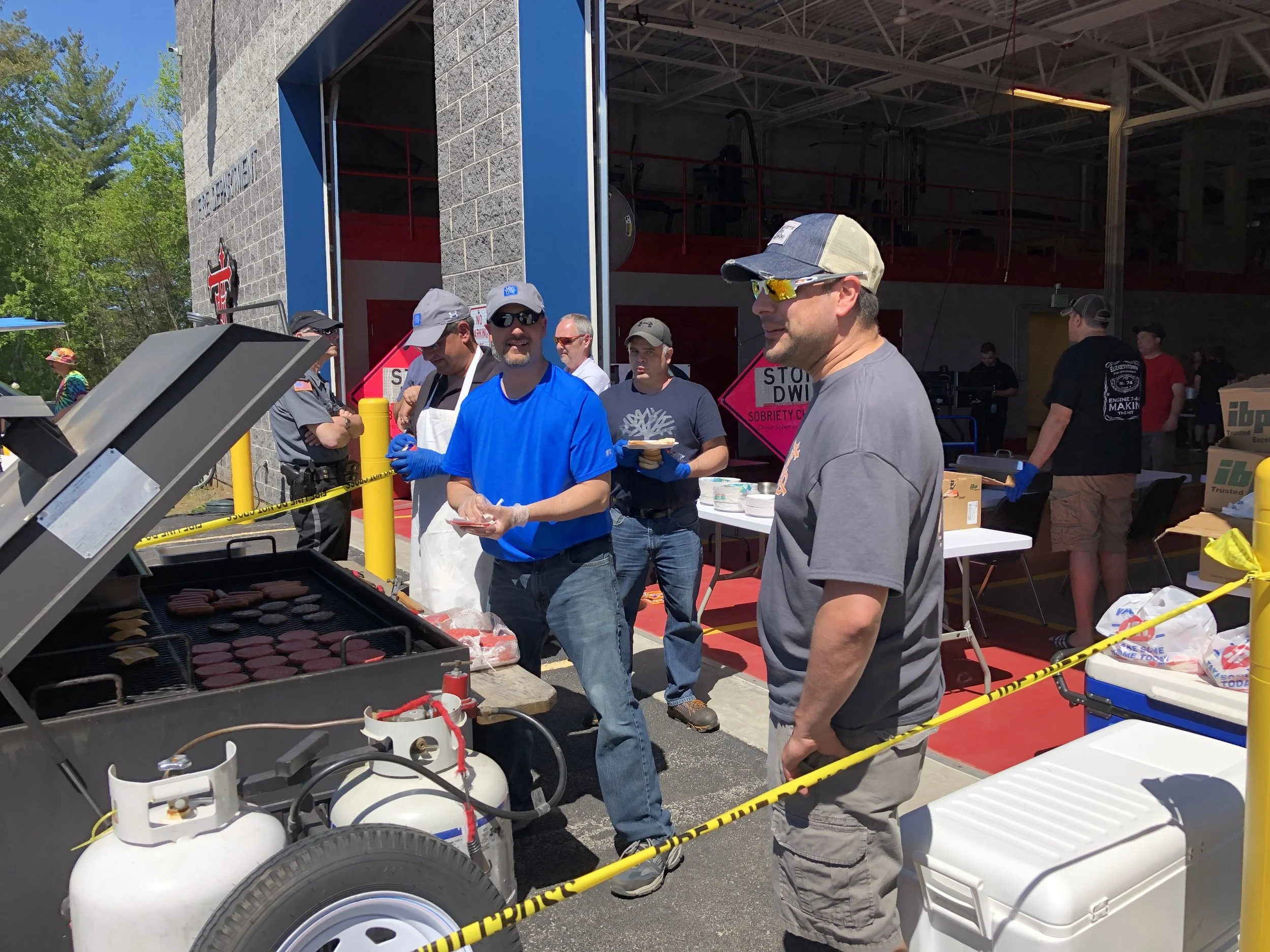 Fire Chief Royce Cole was keeping a close eye Saturday on the food preparation skills of volunteer Rick Reandeau and Police Chief Eric Proulx, who were working the police department's grill at the 13th annual Bike Rodeo.