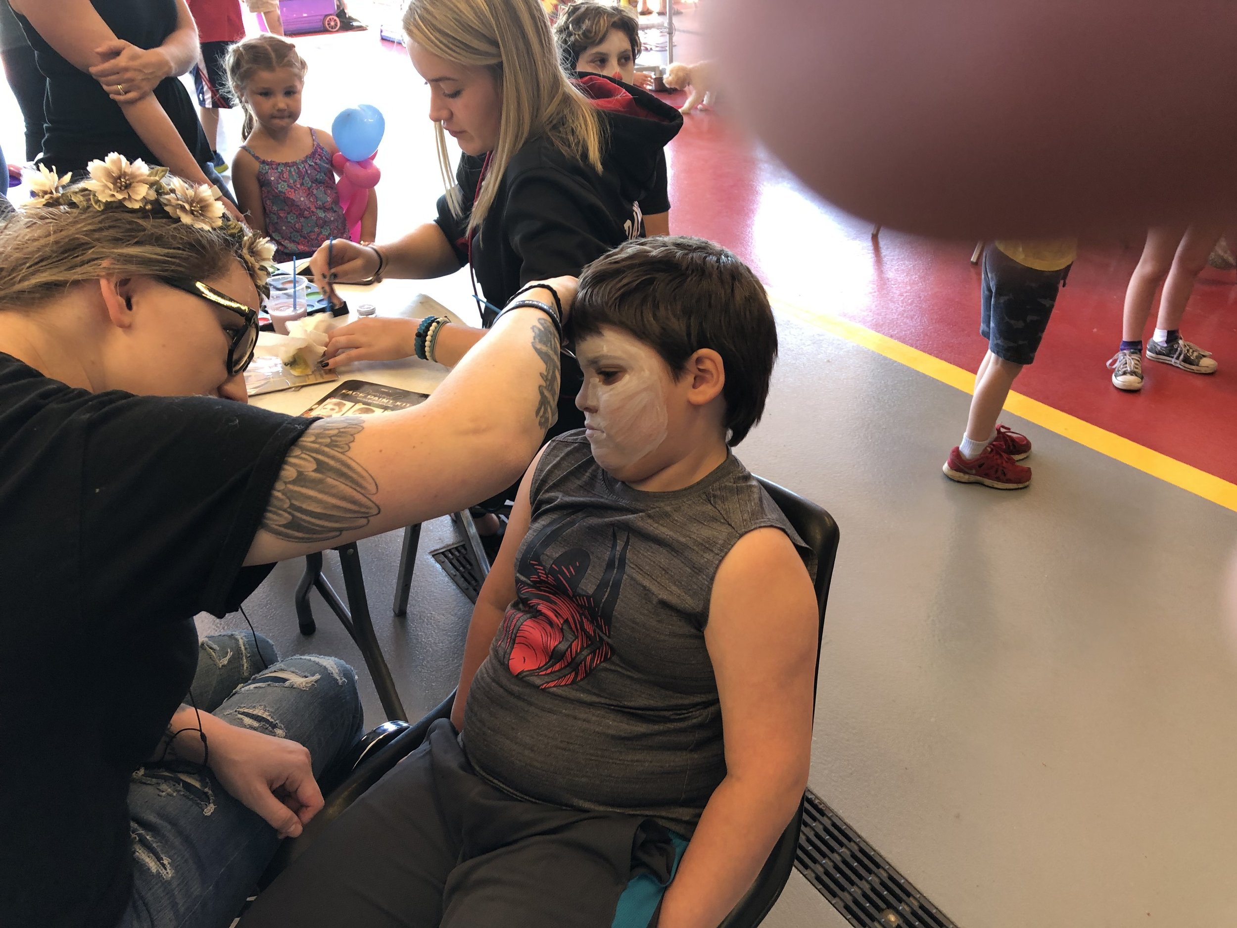   Inside the fire station Saturday were over a dozen booths where children could get free things, including face painting, which was being applied to Albert Colburn (he didn't look that excited) by volunteer Loren Frazier.  