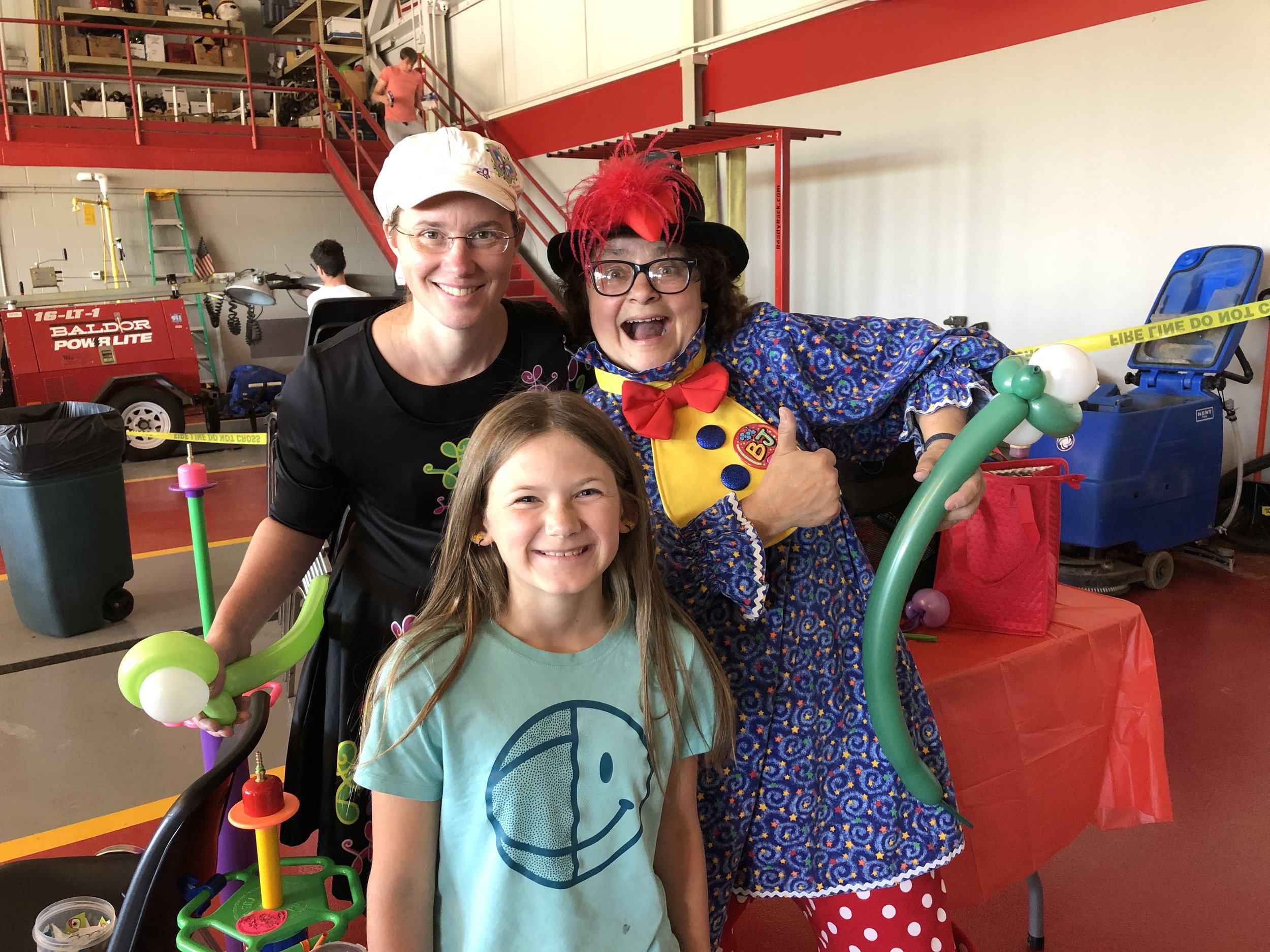   Flutterbug the Clown, a skilled face painter and entertainer, was joined this year by a new clown, BJ. With them Saturday at their booth inside the fire station was their new friend Pailin Hample, who served up a great smile for the Free Press phot