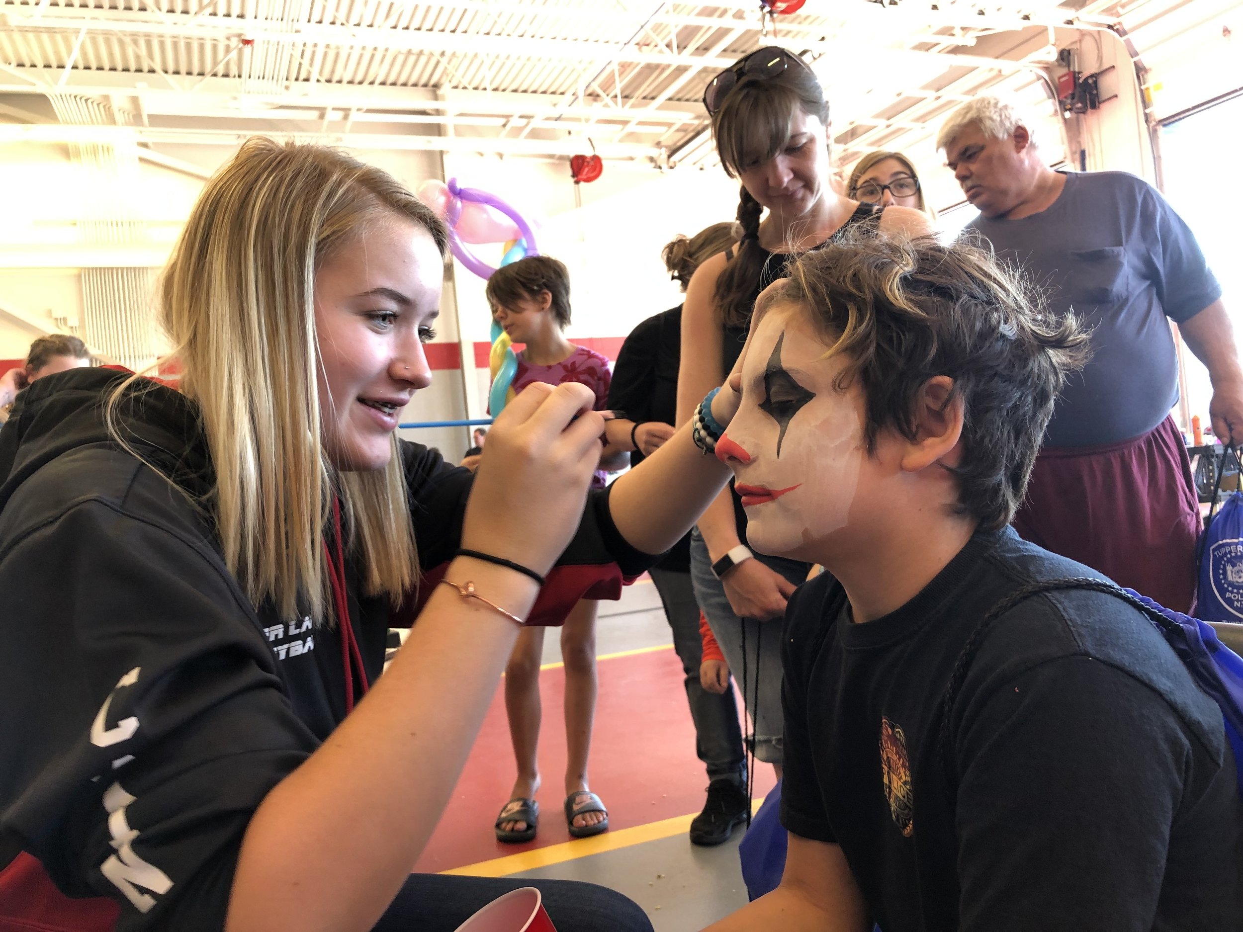   Inside the fire station Saturday were over a dozen booths where children could get free things, including face painting. In the photo Tanner Varden was getting his face decorated by Elaina Daniels.  