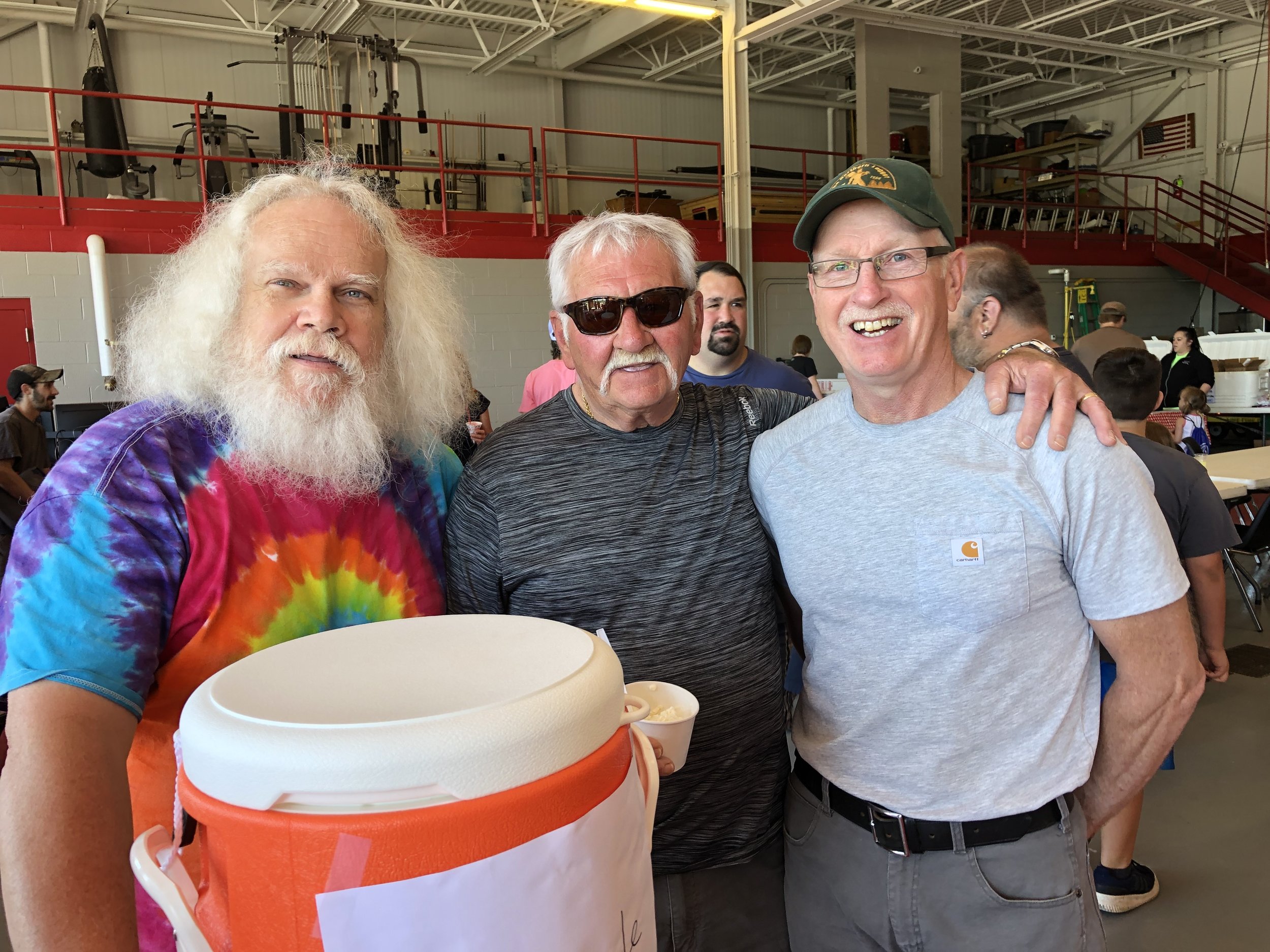   Veteran fireman Mike Russell was serving sweet drinks from two vats Saturday at the bike rodeo and at one point was joined by a couple happy rodeo-goers, Mike Arsenault and Jeff Thomas.  