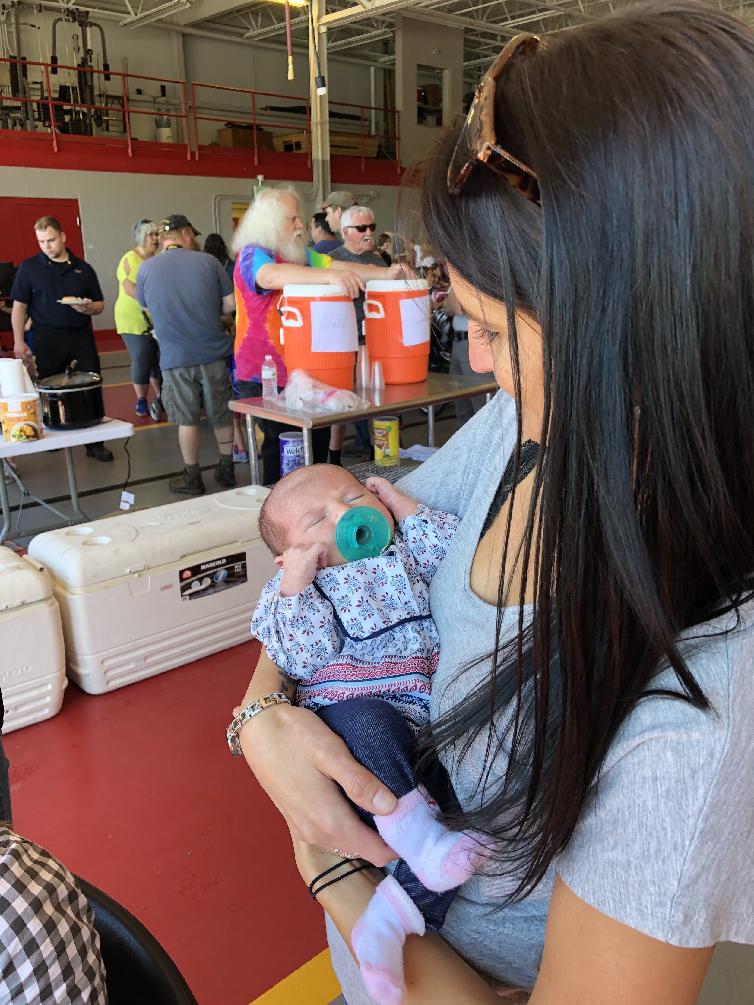   The youngest participant at the 13th annual Bike Rodeo Saturday was week old Kinsley Cole, newborn of Jessica and Royce. Holding the tiny lass was friend Kristin Pelkey.  