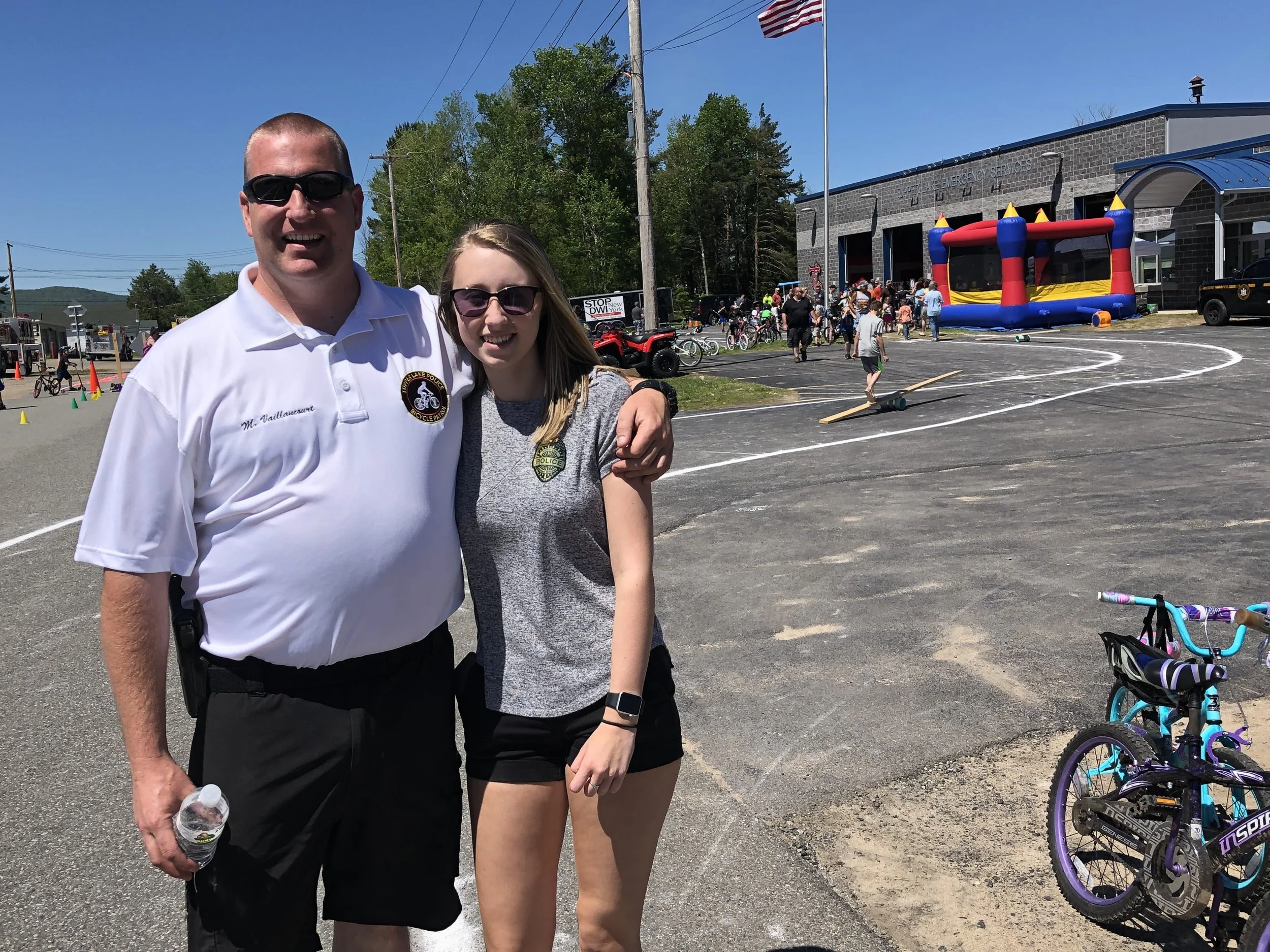 The man who has been the driving force for Tupper Lake's annual Bike Rodeo since 2008, Officer Michael Vaillancourt, was extremely pleased with the great weather Saturday which featured cloudless skies and warm temperatures. Some of Mike's events in the past have met with rain and cool weather, but like the circus, the rodeo always goes on. When things have been really damp in recent years, the event has been moved inside the fire station on Santa Clara Ave. He poses above half way through the multi-faceted event with high school volunteer, Samantha Higgins, who is in tenth grade. Samantha also helped last year. Mike said that day he figures total attendance would top 700 that day, when all riders and their family members were figured into the mix. He said the 60-foot long inflatable obstacle course was a big hit with the kids this year. New this year too was the Franklin County Sheriff's Department new high-axle transport vehicle, which came from the U.S. military and which will be used in flooding situations, where raging and deep water has to be crossed.