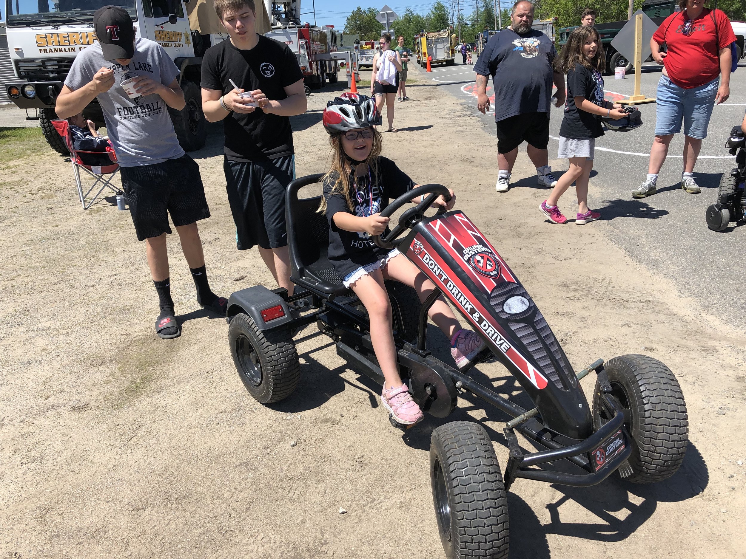   Arianna McLear was just about to don the beer goggles to pilot the motorized rig again brought to the Tupper Lake bike rodeo Saturday by the county's STOP-DWI program. The goggles simulate what it is like to operate a vehicle while under the influe