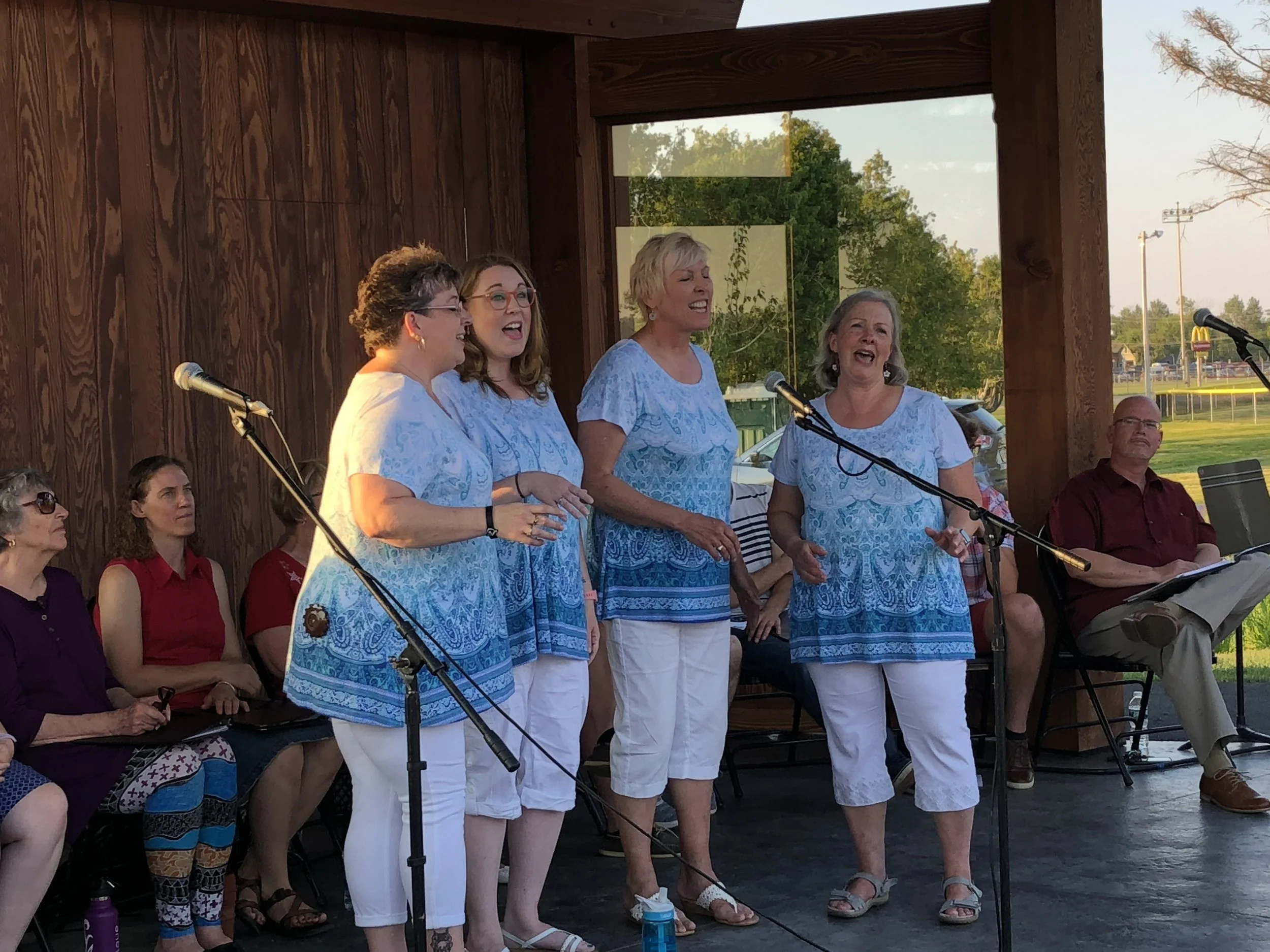 The second group to perform there as part of Tupper Arts' Summer Sunset Series was put together by Tupper Arts mainstays Liz and George Cordes and their associates in High Peaks Opera, past and present members of the local Red and Black Players, and the female barbershop quartet called Fourtissimo- all coming together that night as “Making a Raquette.” The show featured many strong solo and group numbers, many of them very appropriate to bring in America's Independence Day Thursday with tunes like “This Land is Your Land” and “God Bless America. A number of popular show tunes were also performed. Among those on the Sunset Stage were (not in order) Carol Lamb, Deanna Courtney, Gretchen Reid, Danielle LaMere, Karyn Ryan, Harriet Connelly, Hannah Zehr, Kirsten Denis, Kathleen Lefebvre, Stephanie Fortune, Michell Jensen, Matt Varden, Ian Gillis and Noah Cordes.