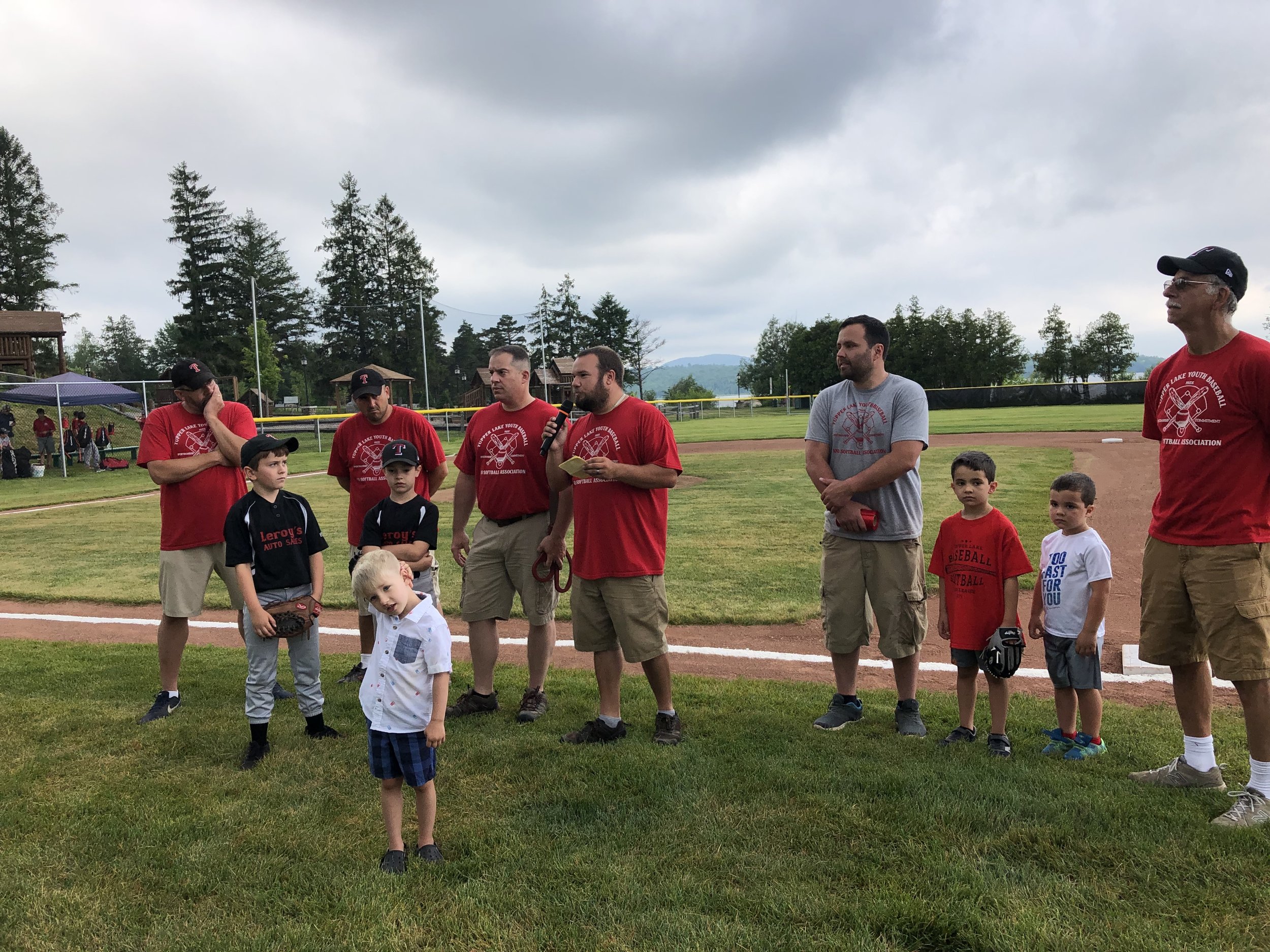   Tupper Lake Youth Softball and Baseball Association president Dan Brown (at center), with his directors and their children, had high praise for all those who helped and all those who contributed to the creation of the new $100,000 plus Little Leagu