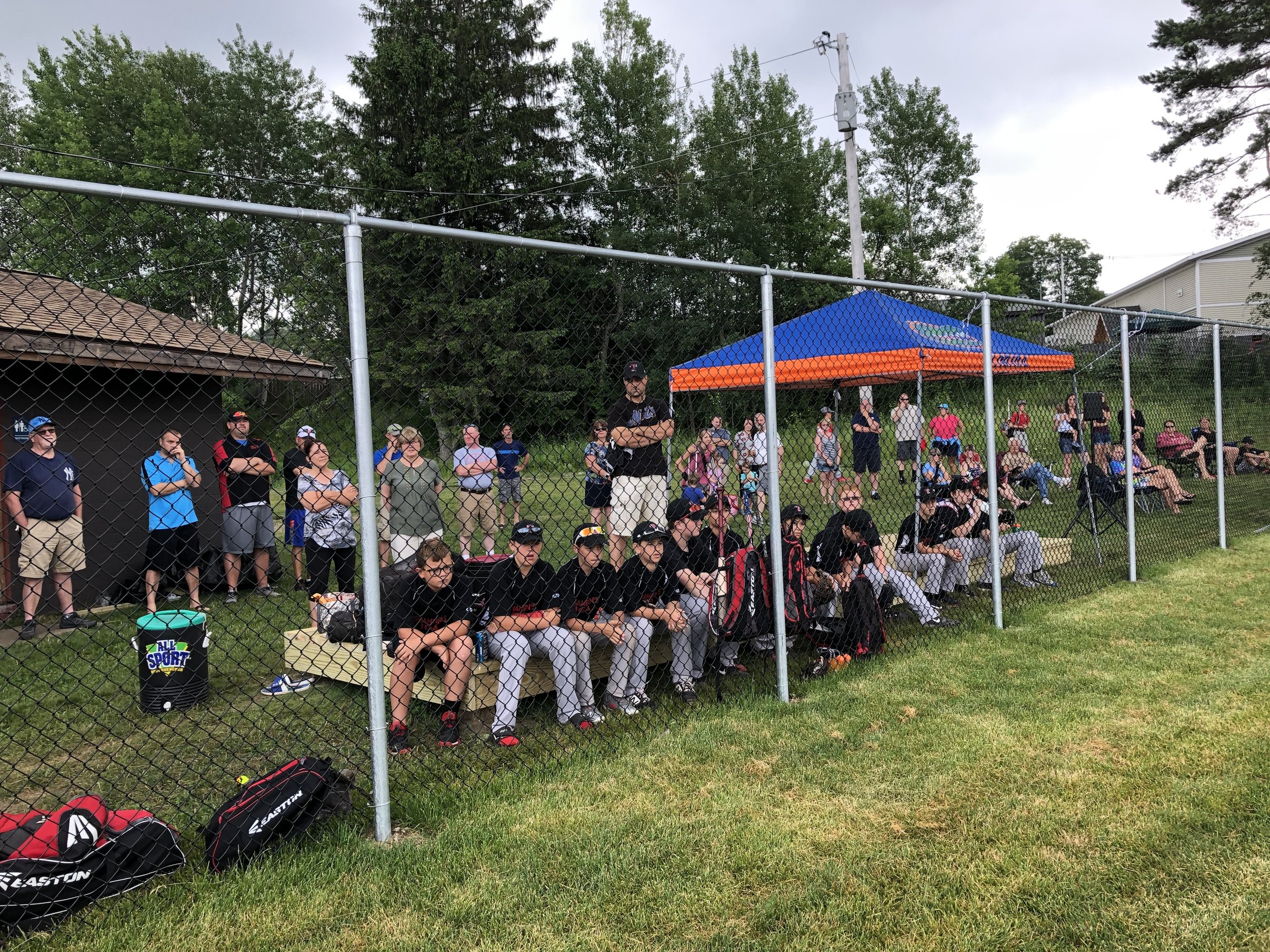   Tupper Lake baseball players listen to the opening ceremonies Saturday before the ribbon-cutting of the new field adjacent to the Little Logger Playground in the municipal park.  