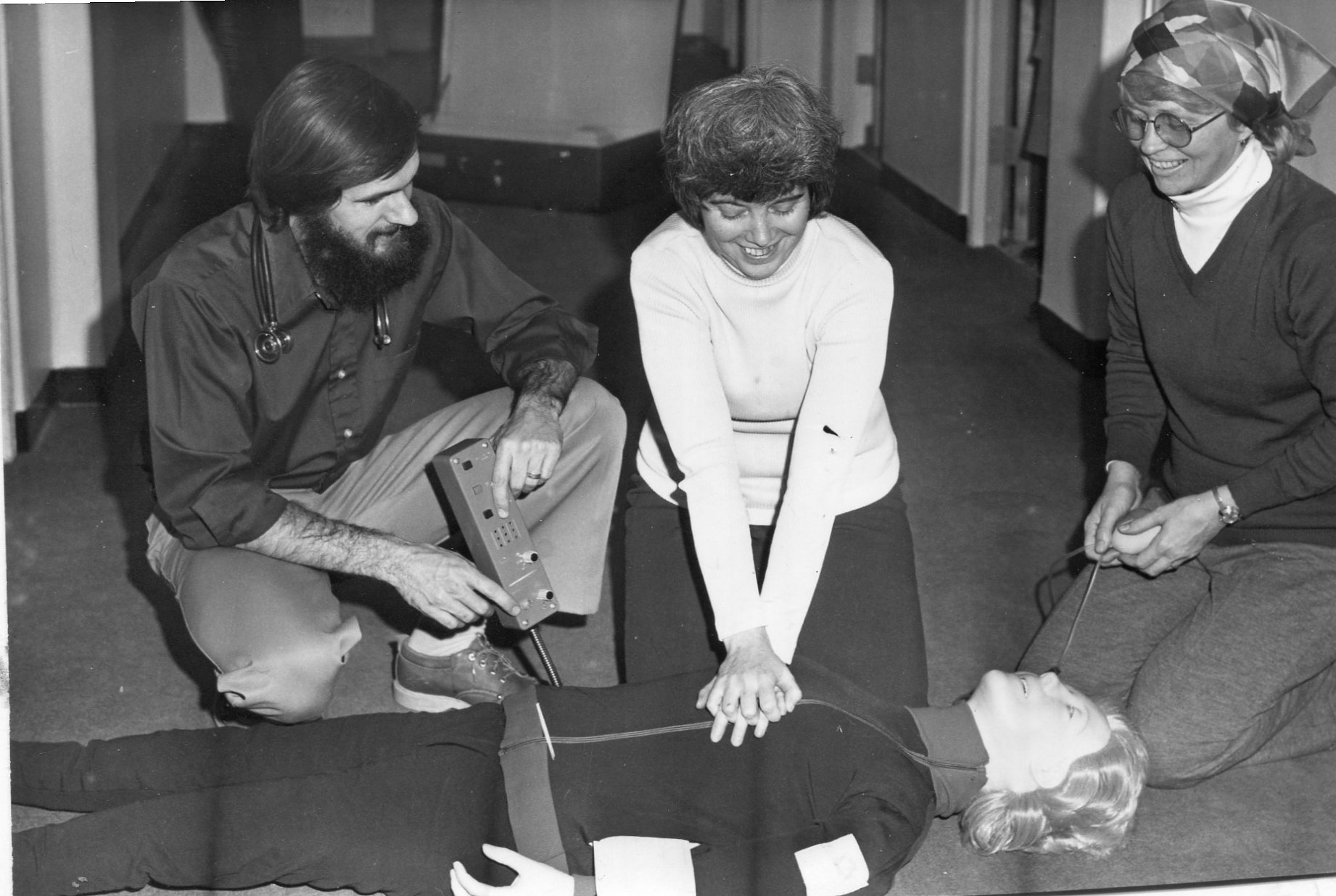   Dr. David Johnson was instructing Carol Merrihew and Jane Johnson on the techniques of CPR with Resuscitation Annie in the 1980s.  