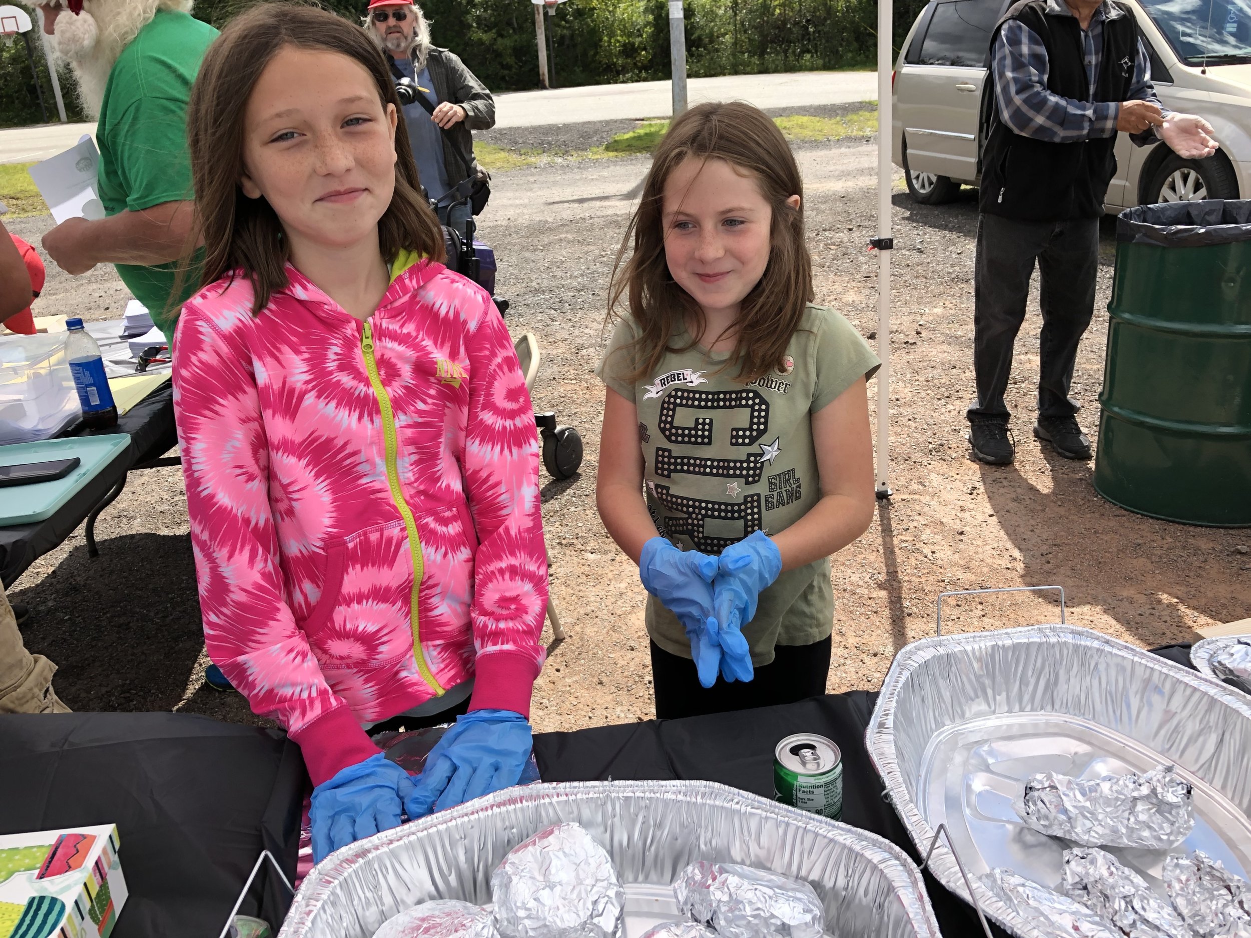   Brina Reandeau and Eliza Bujold, who are part of Tupper Lake's new New York Life family, were helping distribute freshly grilled hot dogs and hamburgers to voters Saturday.  