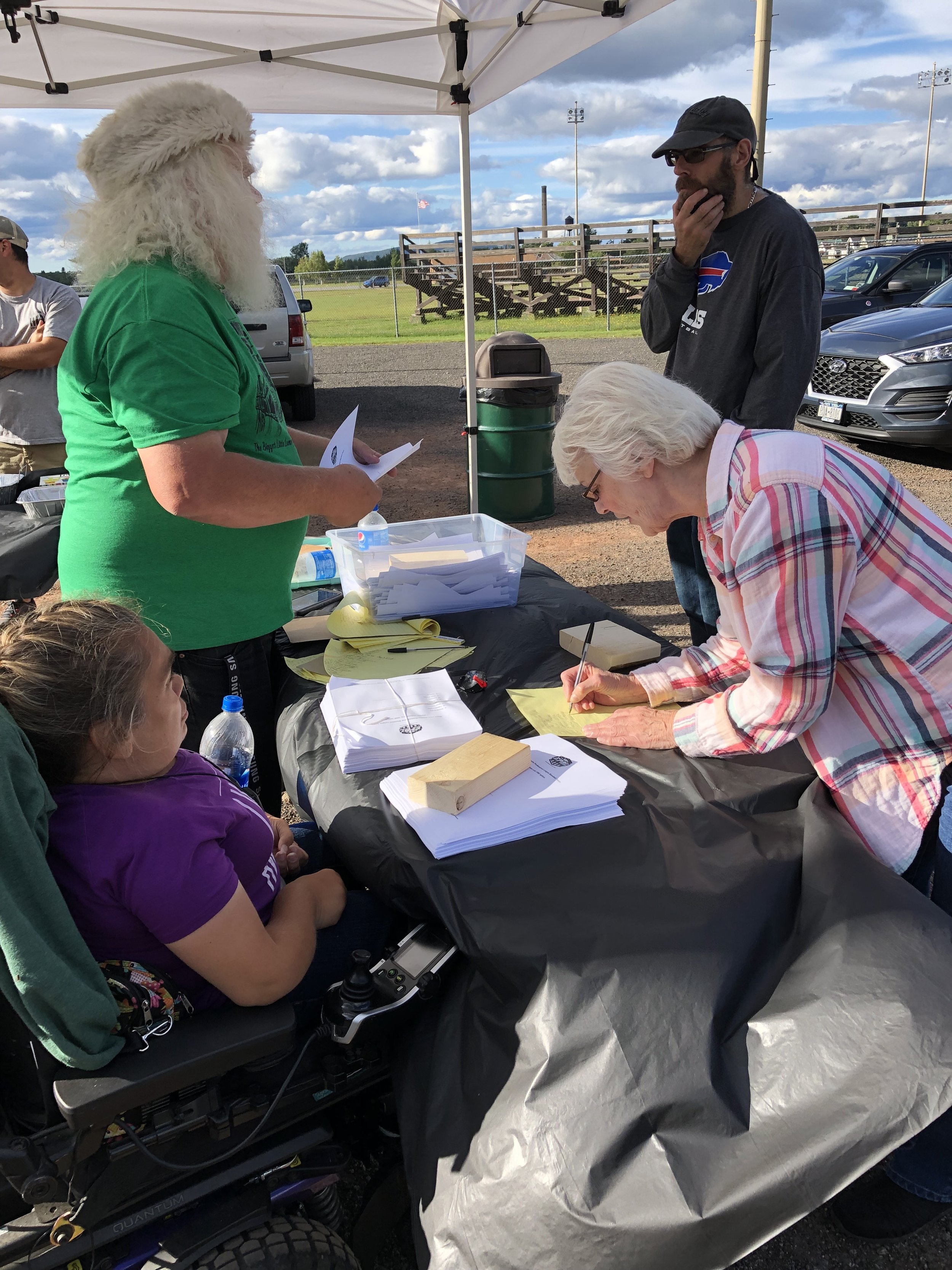   Mike Russell, a.k.a. Santa Claus, and his daughter Christine manned the voting booth for all six hours Saturday, making sure everyone registered and keeping the paper ballots orderly. Voting above was Carol Beaudette, who brought along her mother, 