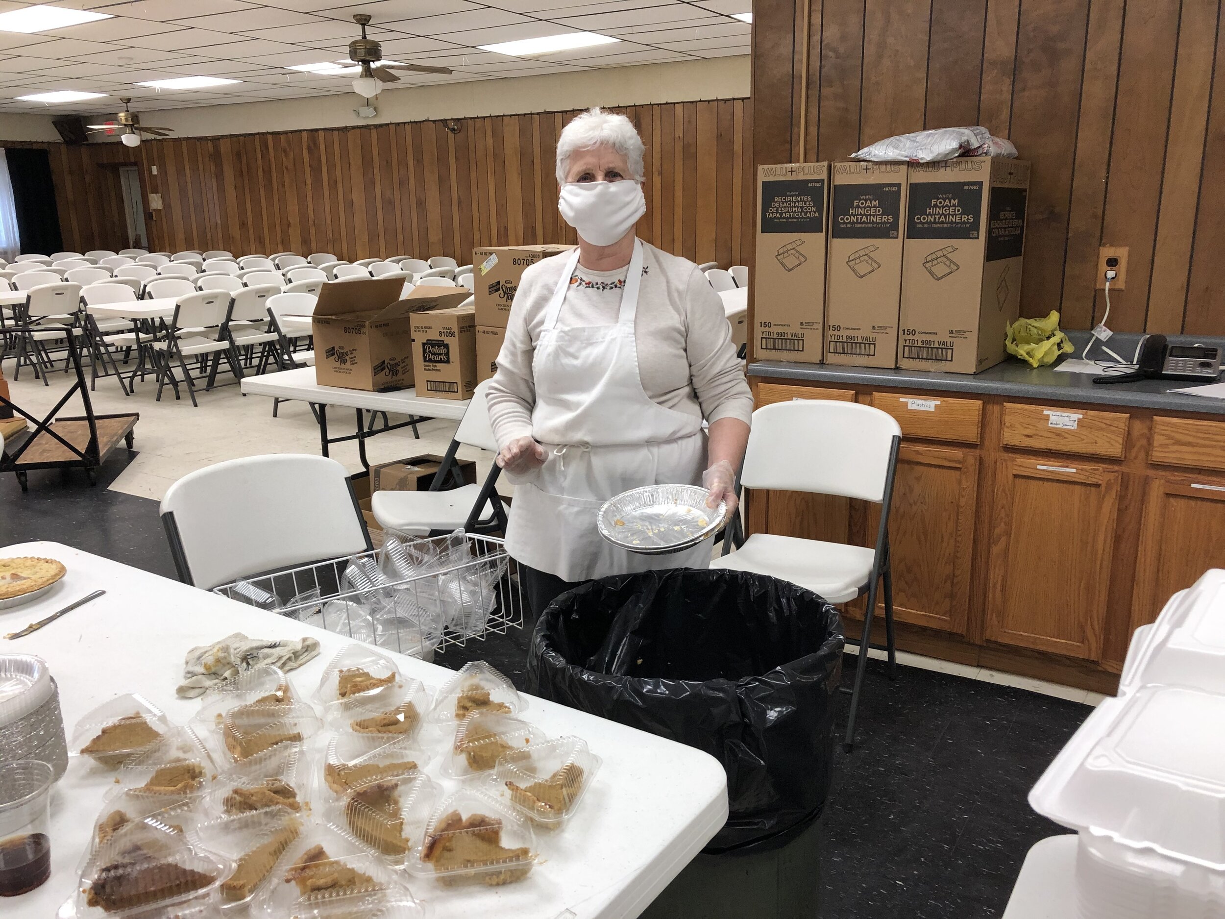    Sunset Avenue's Carol Peets, a member of the Fortier clan that is the backbone of the annual community Thanksgiving dinner here, was busy just prior to meal time Thursday slicing pumpkin pies and placing the slices in individual plastic containers
