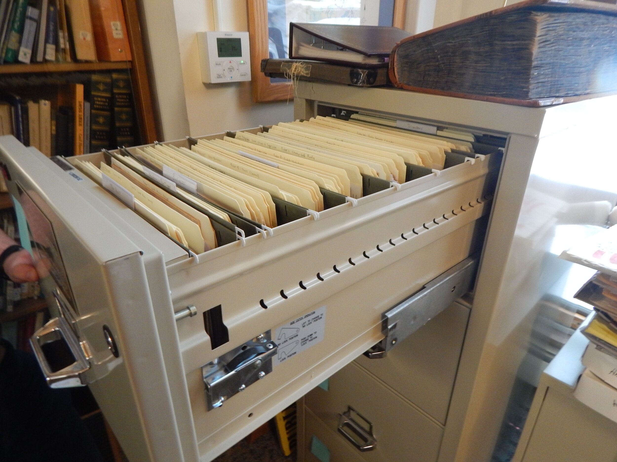    A cabinet full of filed photographs regarding Tupper Lake history.    