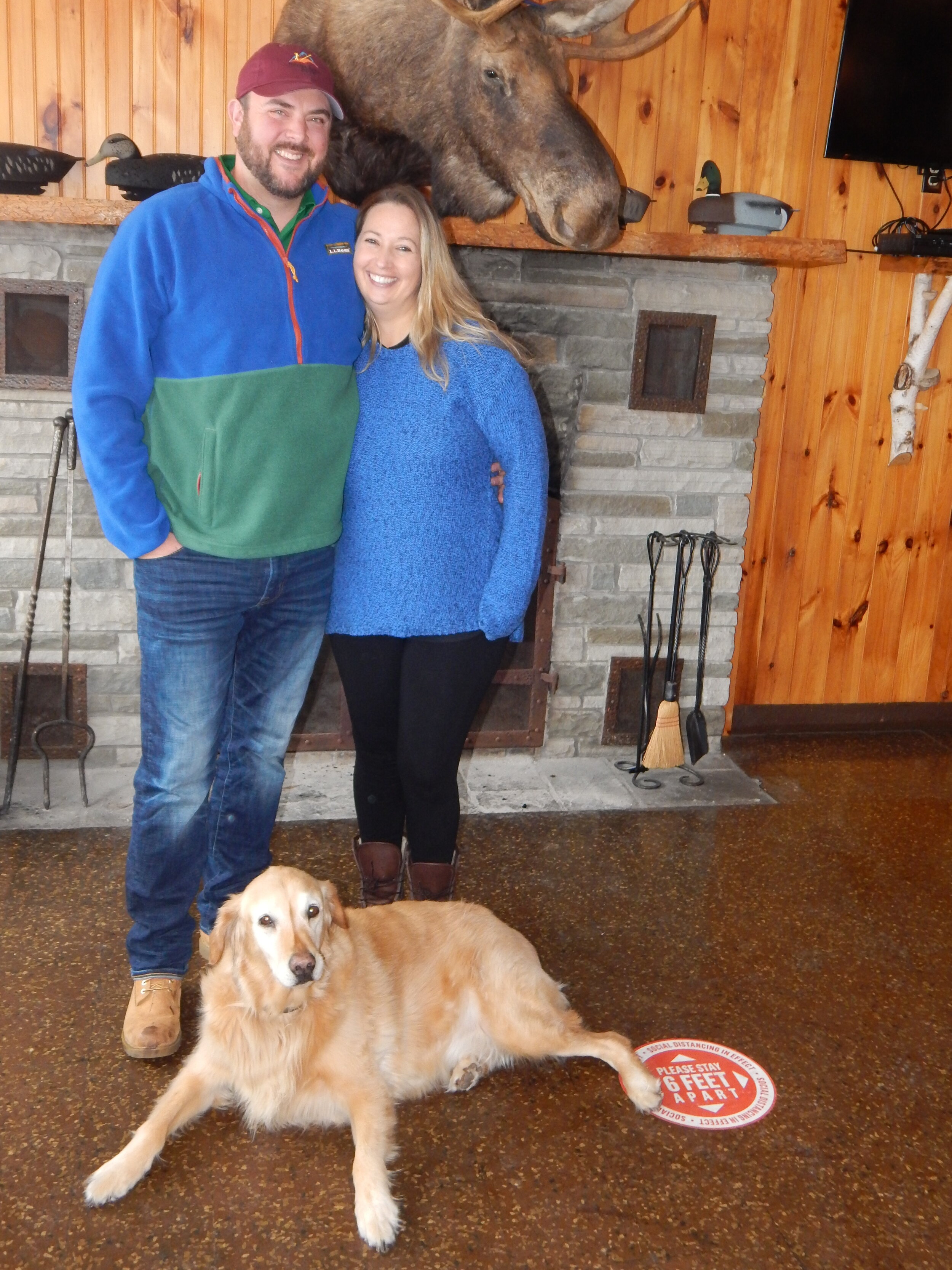    Jaime and Rachel Armstrong, new proprietors at The Lookout restaurant, formerly The Burgundy Steakhouse and the 19th Hole Restaurant, at the Tupper Lake Golf Course, pose with their dog Louie in front of just one of the new editions at the venue -