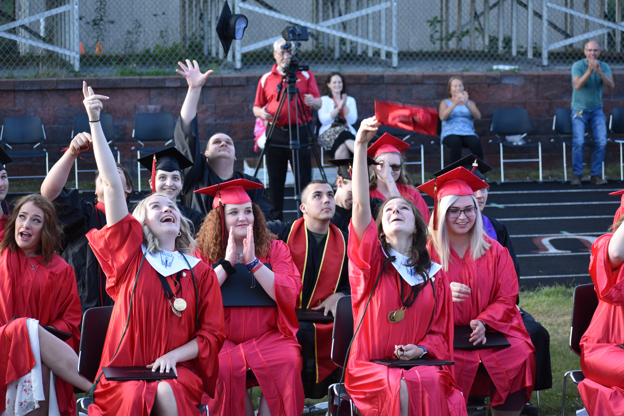    Members of the Tupper Lake High School Class of 2021 toss their caps into the air and celebrate moments after they were told to flip their tassels over and officially became high school graduates. (Rich Rosentreter photos)  