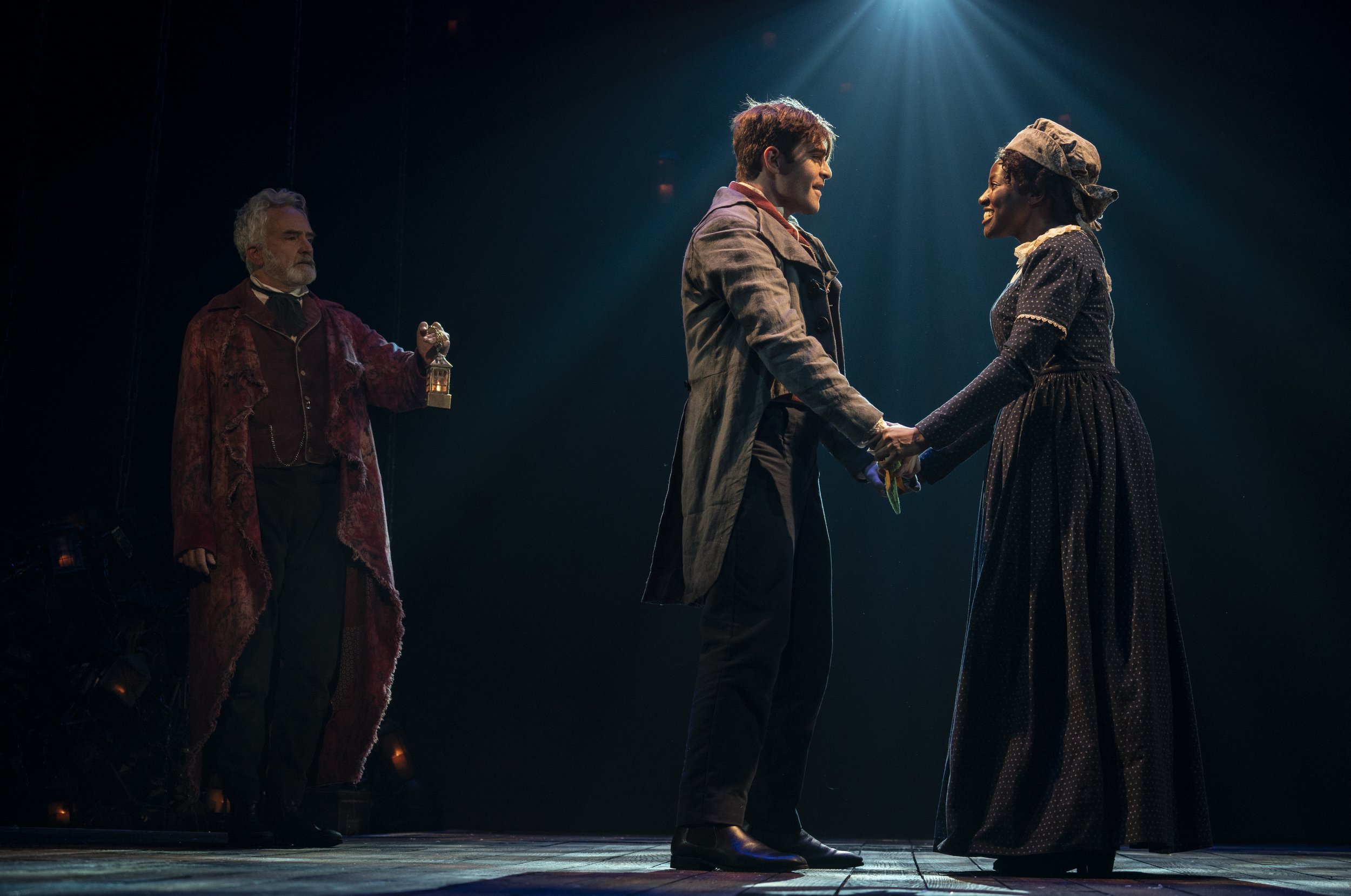 0317r_Bradley_Whitford_Harry_Thornton_and_Glory_Yepassis-Zembou_in_A_Christmas_Carol_photo_by_Joan_Marcus.jpeg