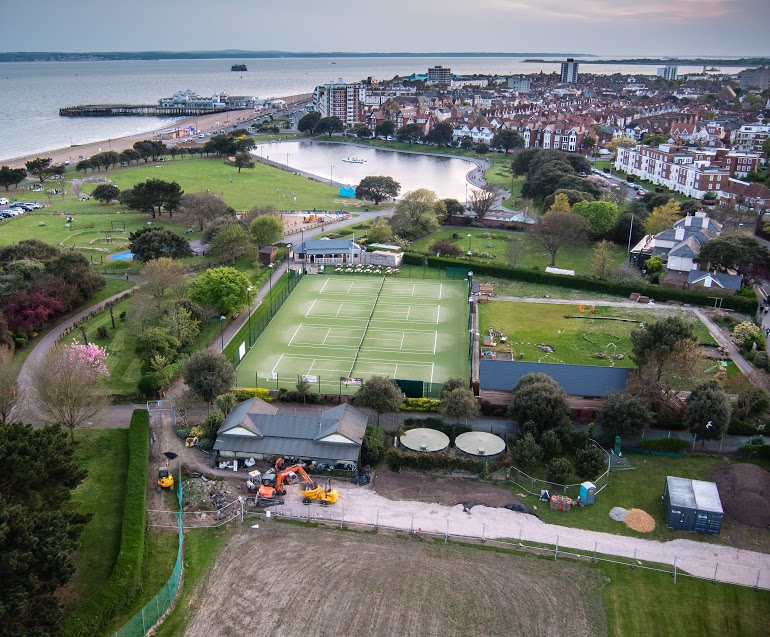 The existing pavilion with haul road under construction. Two storage containers are visible while two accommodation units are yet to arrive. Four all weather courts and the cafe are just behind. 