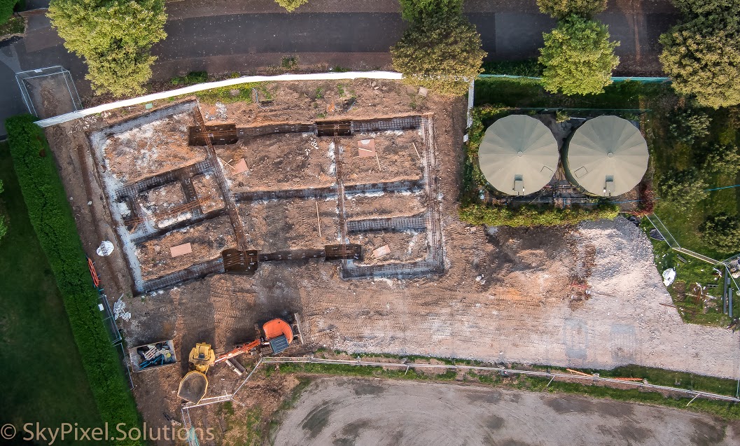Steel reinforcement being installed on top of mass foundations in preparation for steel reinforcement. Also visible are four foundation pads with holding down bolts to take steel columns.