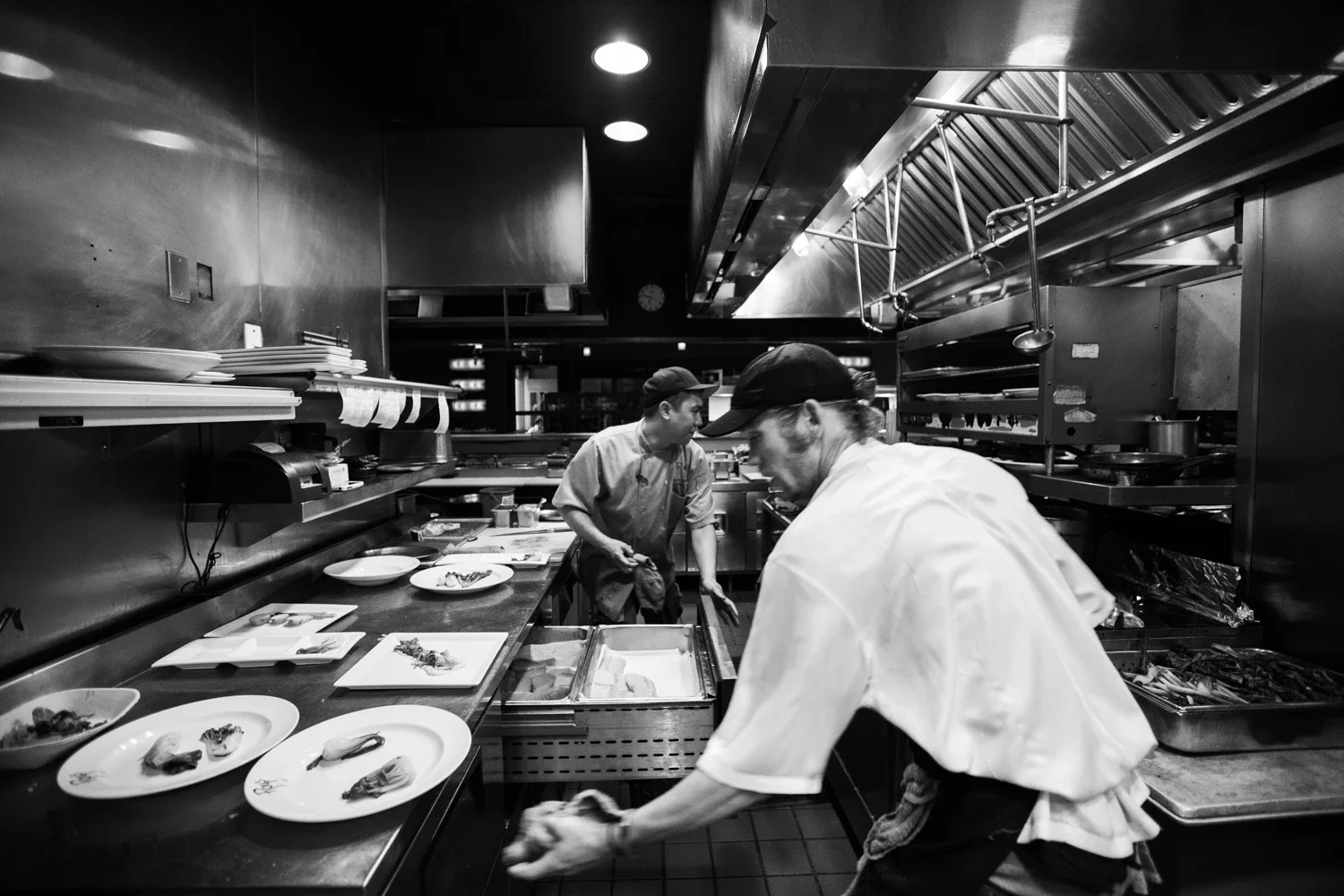 Two chefs working in tandem in the busy kitchen