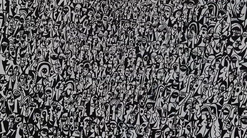 A black and white abstract mural with many stylized human faces and figures.