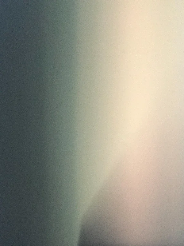 Blurred gradient with shades of green, yellow, and gray.