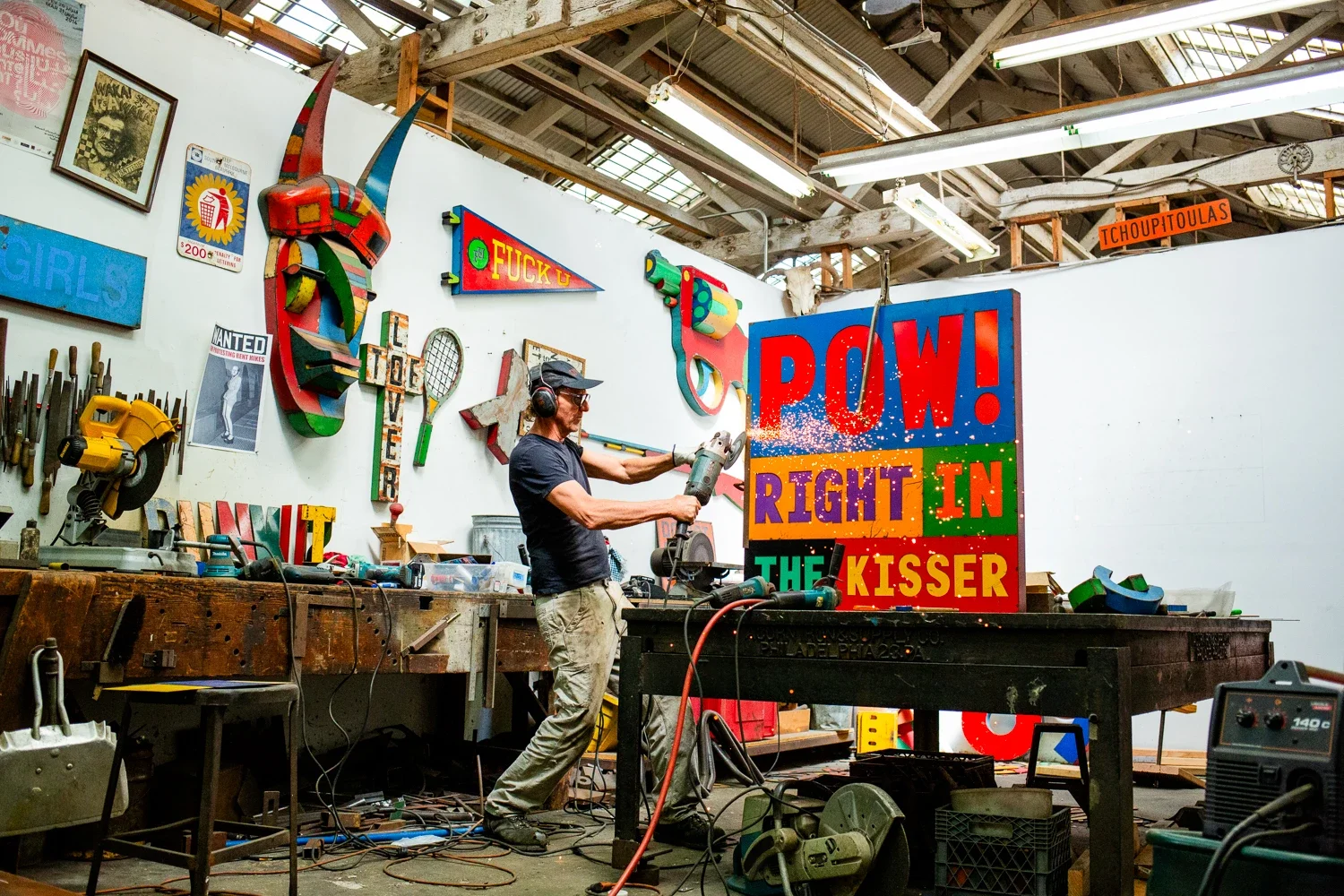 David Buckingham grinding a large metal artwork in his studio