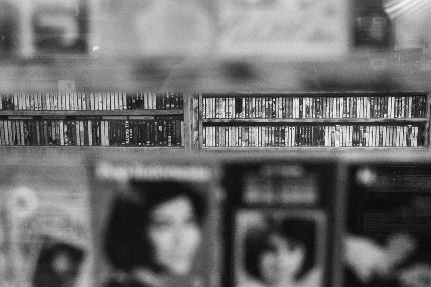 Rows of cassettes behind the visible cassette tape album covers in Blok M photographed by Erwin Darmali