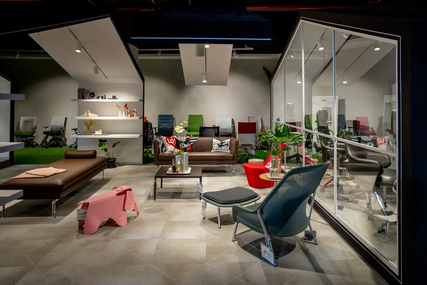 Modern furniture showroom with chairs, sofas, and decorative items displayed in a well-lit space.